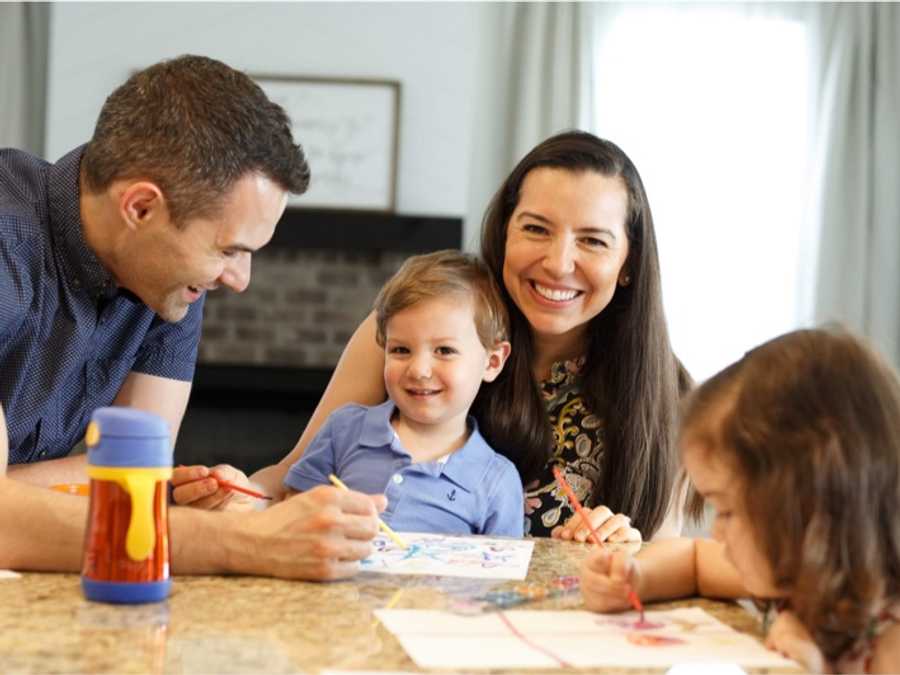 Davidson Homes homeowners sitting in a kitchen as a family.
