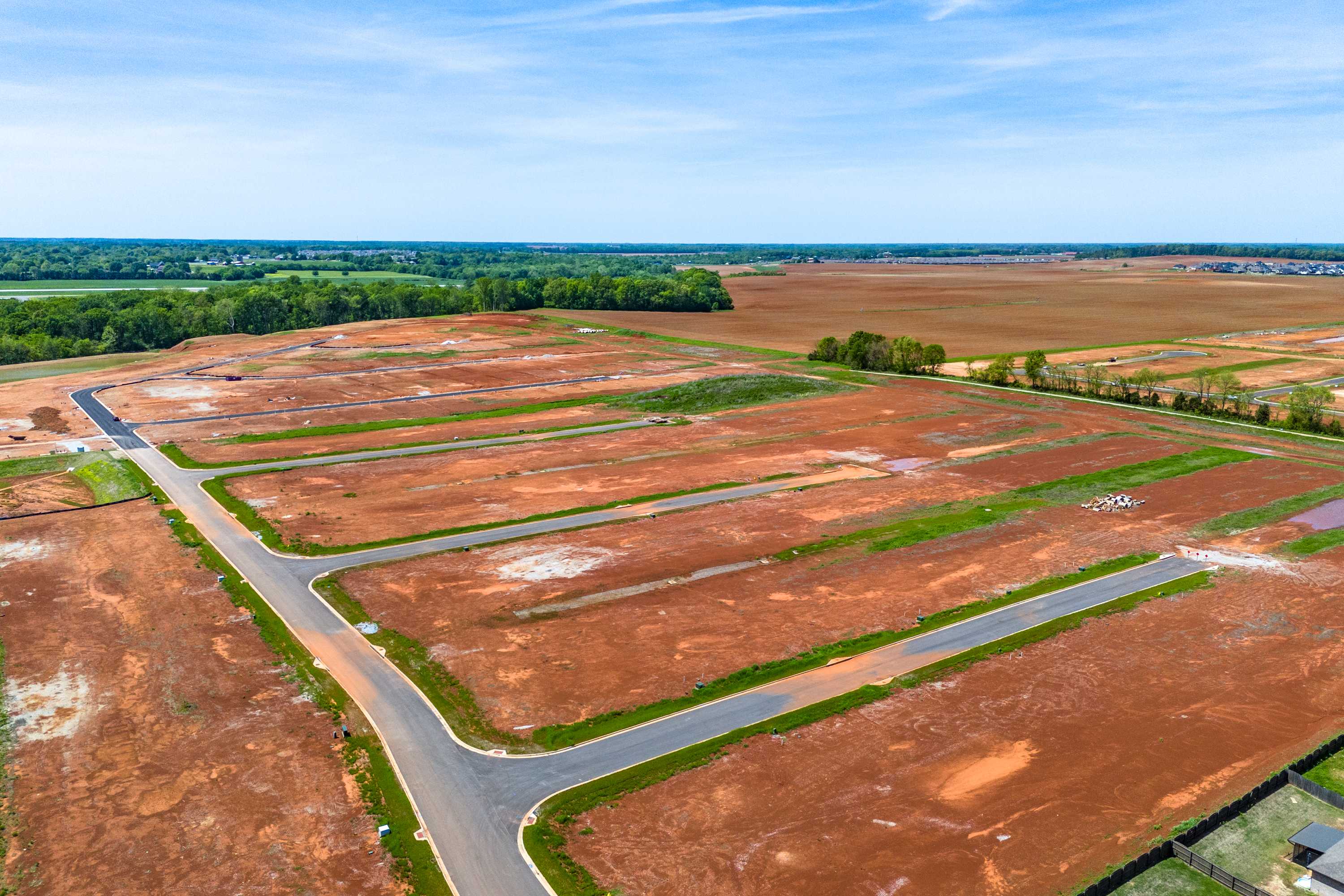 Aerial view of Briercreek neighborhood development in Meridianville Alabama with new home lots roads and surrounding fields by Davidson Homes