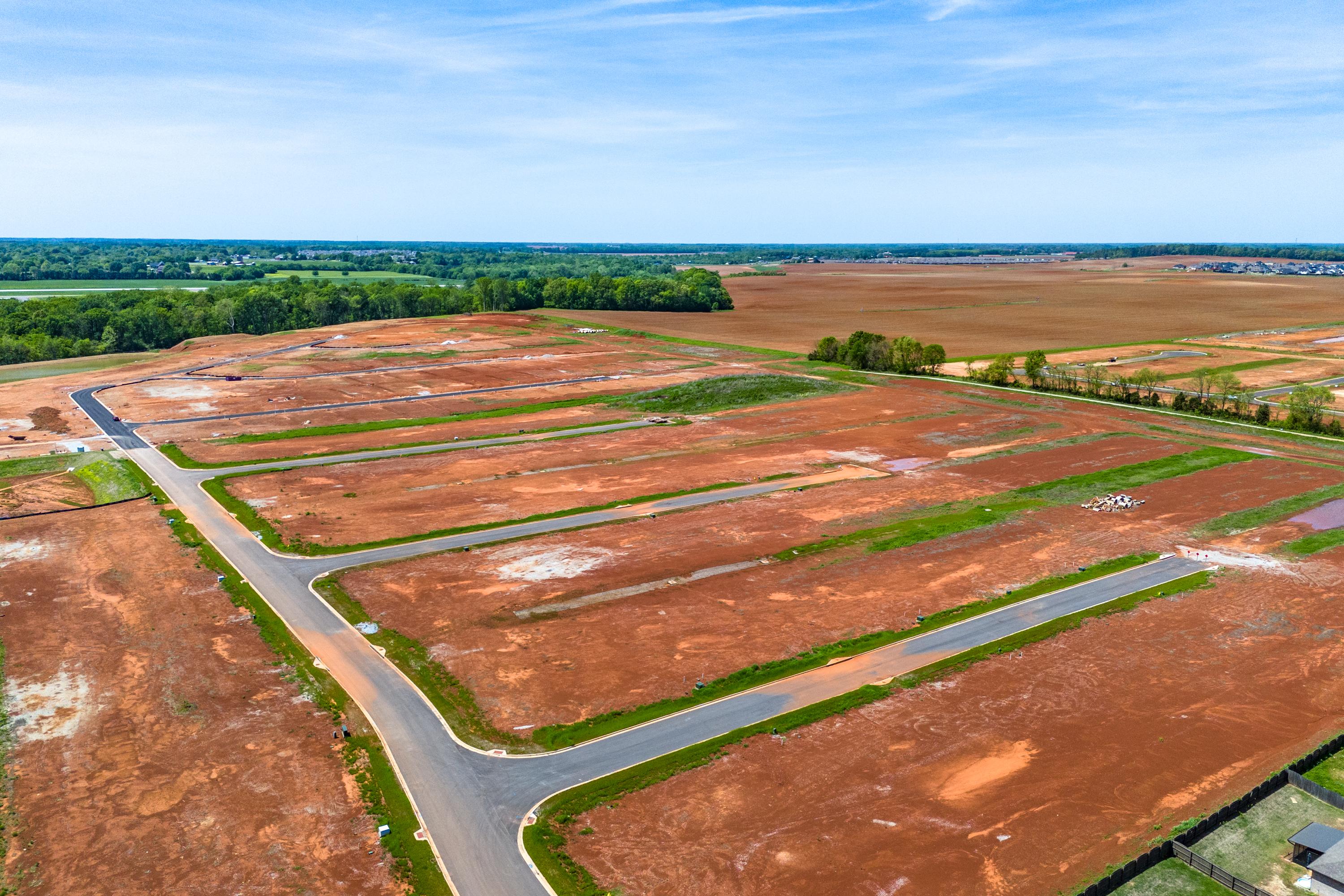 Aerial view of Briercreek neighborhood development in Meridianville Alabama with new home lots roads and surrounding fields by Davidson Homes