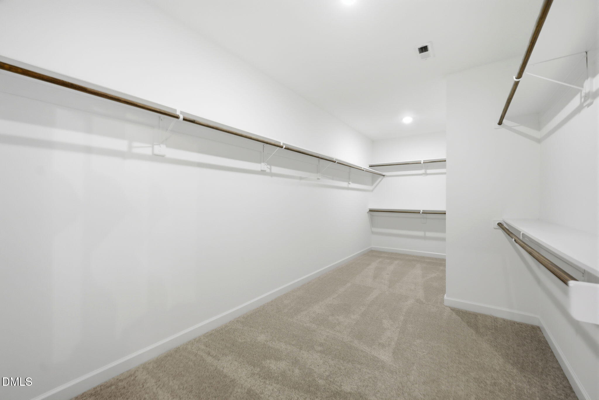 Spacious walk-in closet with shelving in The Aspen B floor plan at Wendell Ridge, Wendell, North Carolina.