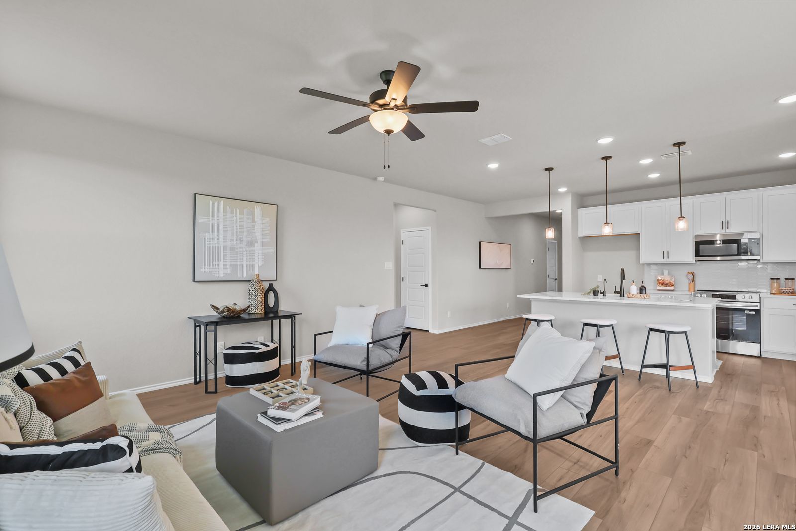 Open-concept living room and kitchen in The Daphne H floor plan by Davidson Homes at Hannah Heights, Seguin, Texas.