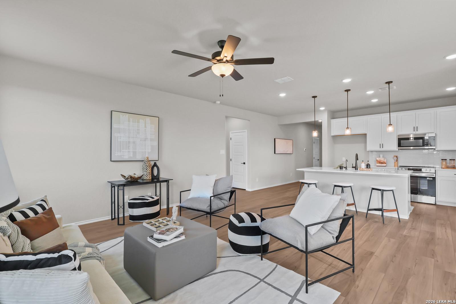 Open-concept living room and kitchen in The Daphne H floor plan by Davidson Homes at Hannah Heights, Seguin, Texas.