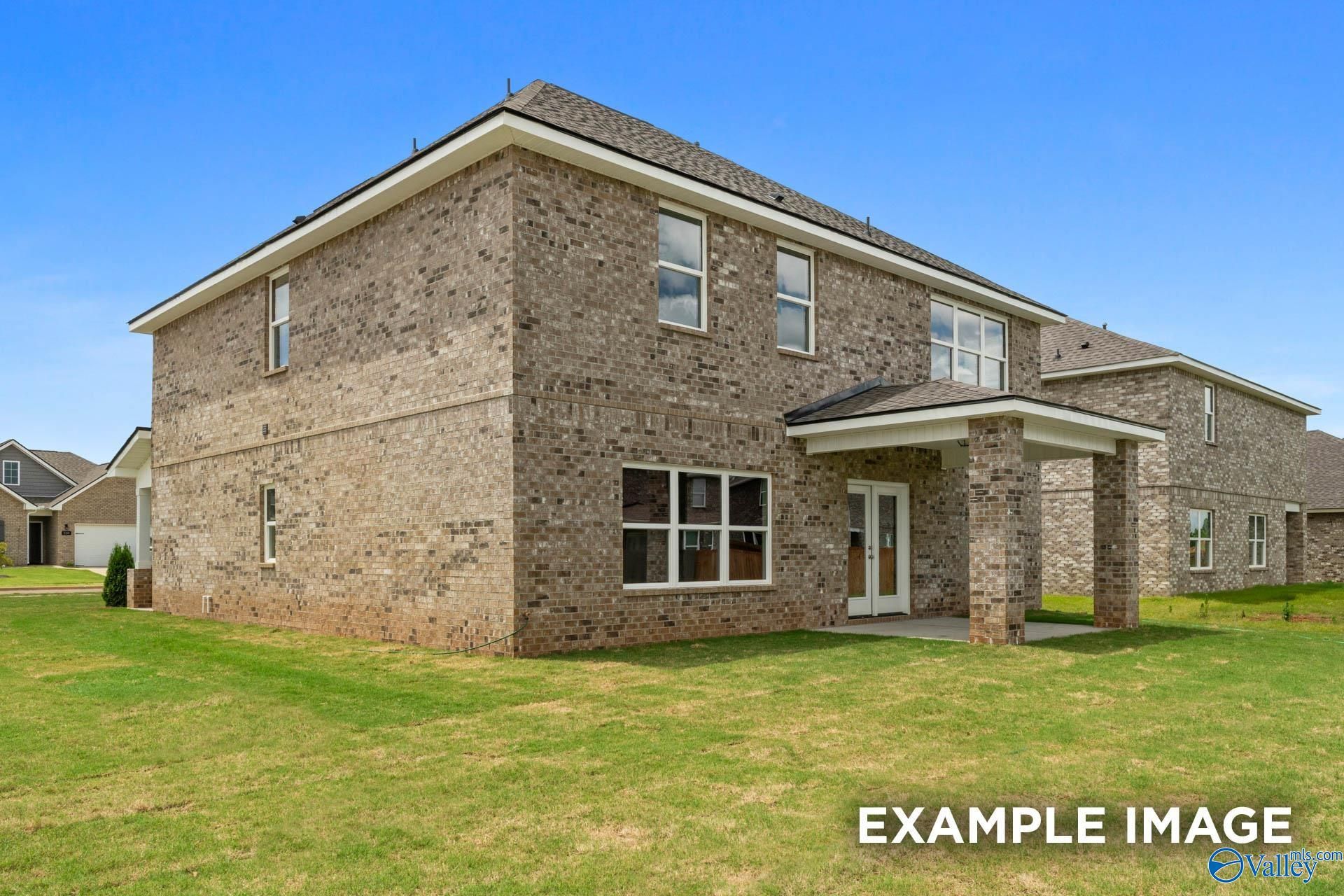 Two-story brick home with covered porch, garage, and green yard in Ivy Hills, Toney, Alabama by Davidson Homes