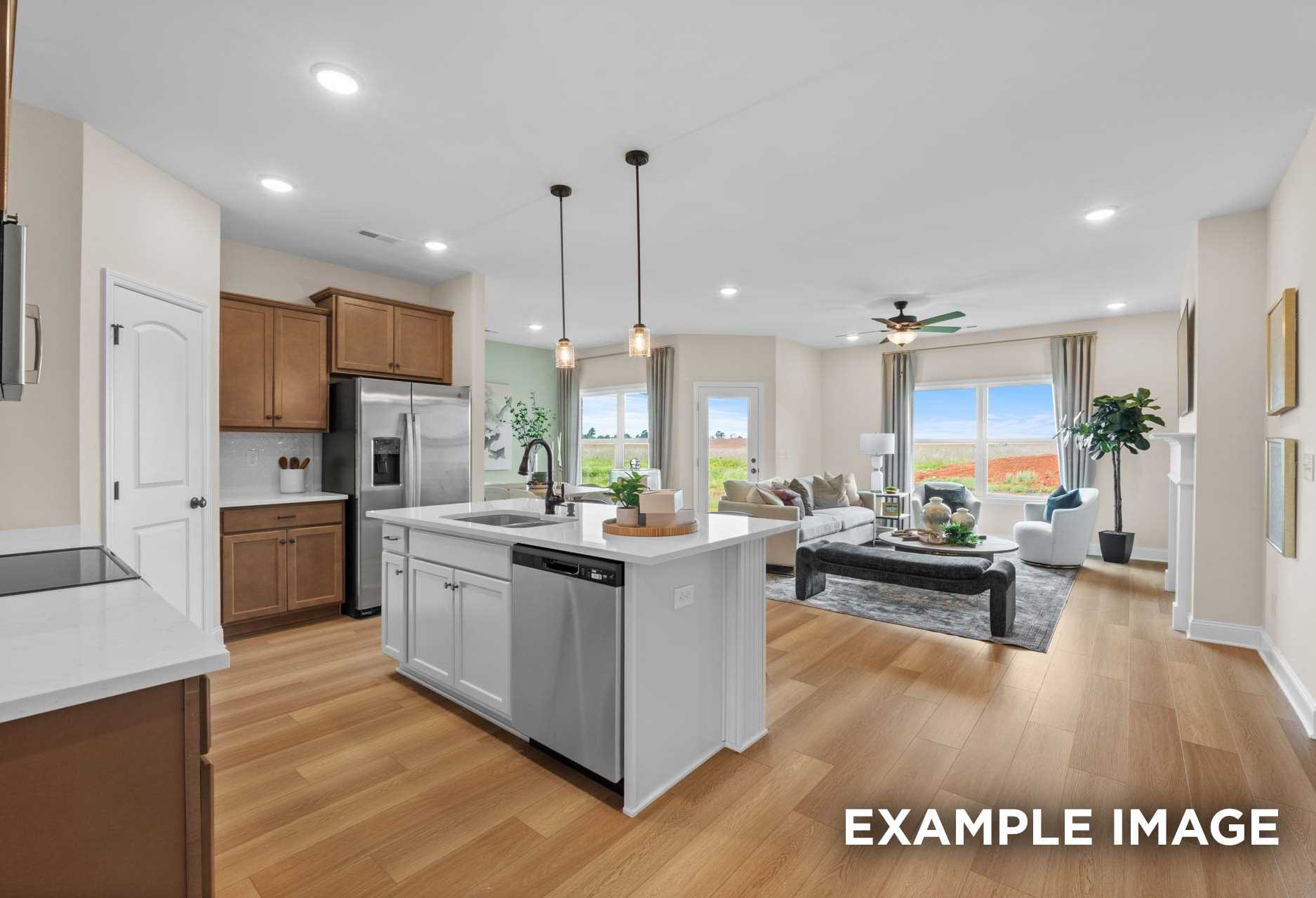 Spacious open-concept kitchen and living area in The Laurel M with white shaker cabinets, large island, stainless appliances, and large windows