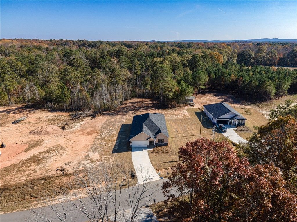 Aerial view of The Orion 4-bedroom single-story home by Evermore Homes in Silver Oak, Cusseta, Alabama, amid pine forest