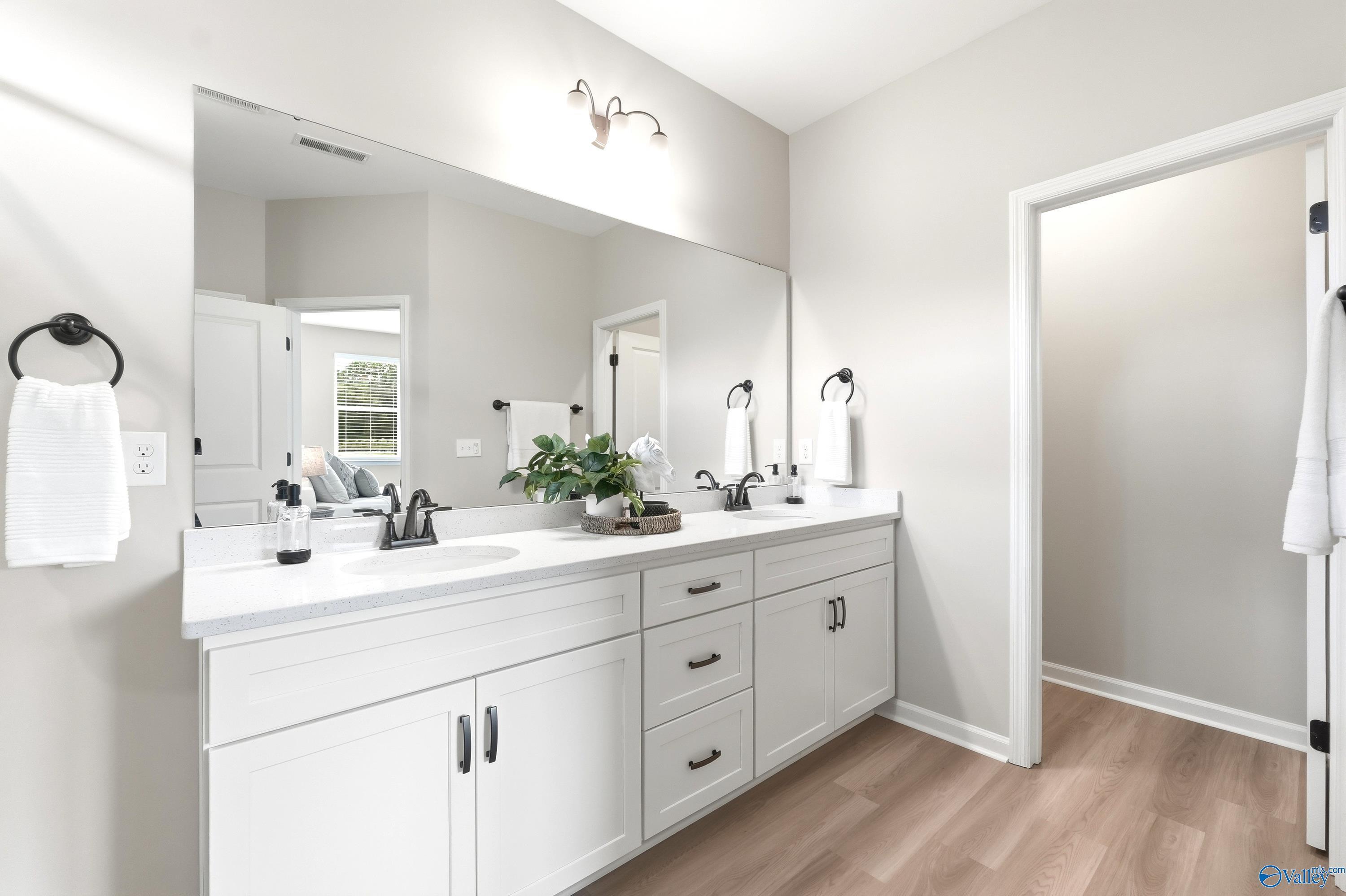 Modern double vanity with white cabinets and quartz countertops in The Dorado floor plan, Riverton Preserve, Huntsville.