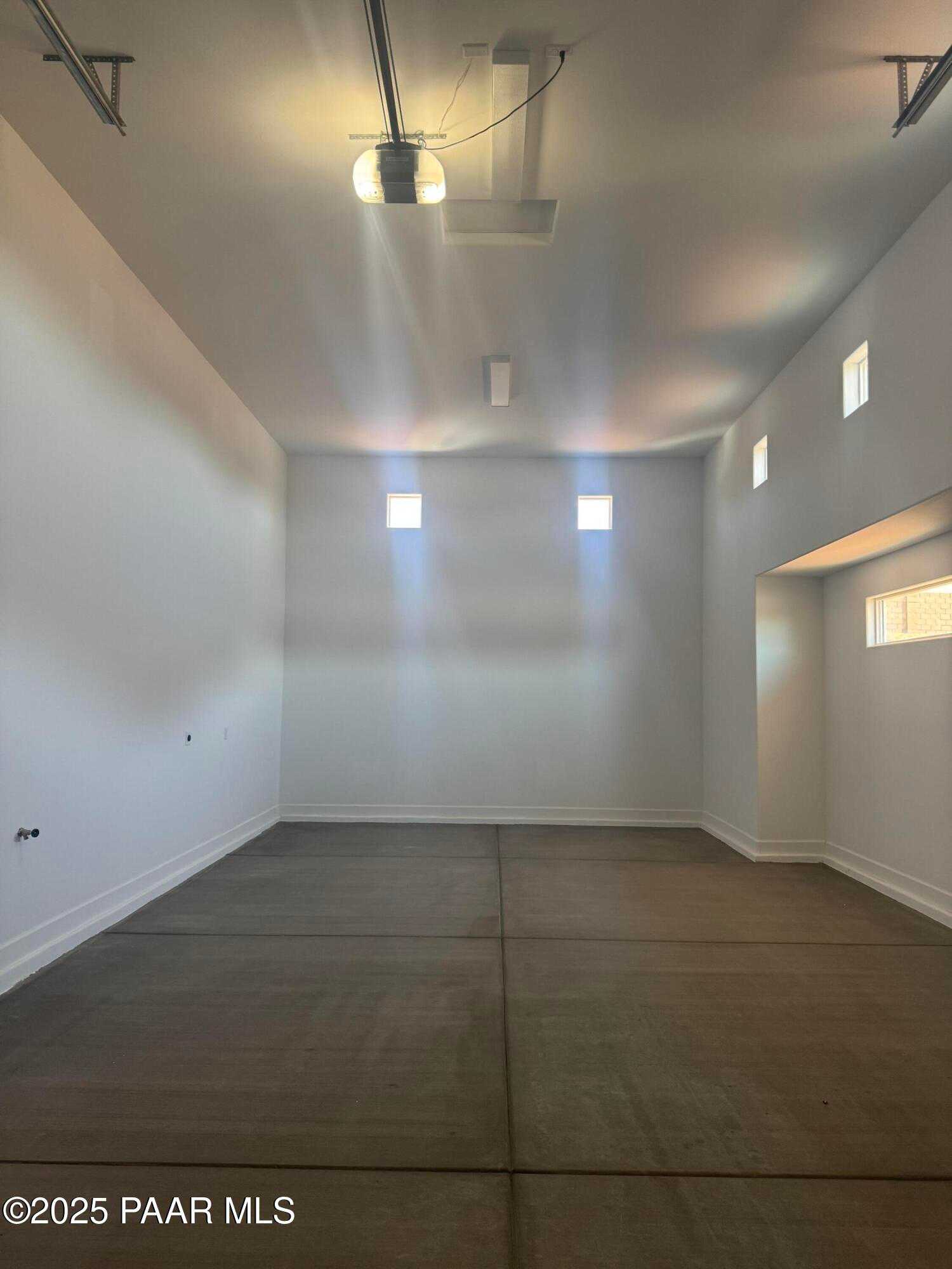 Spacious 2-car garage with polished concrete floor and clerestory windows in Evermore Homes The Summit B, Prescott Valley, Arizona