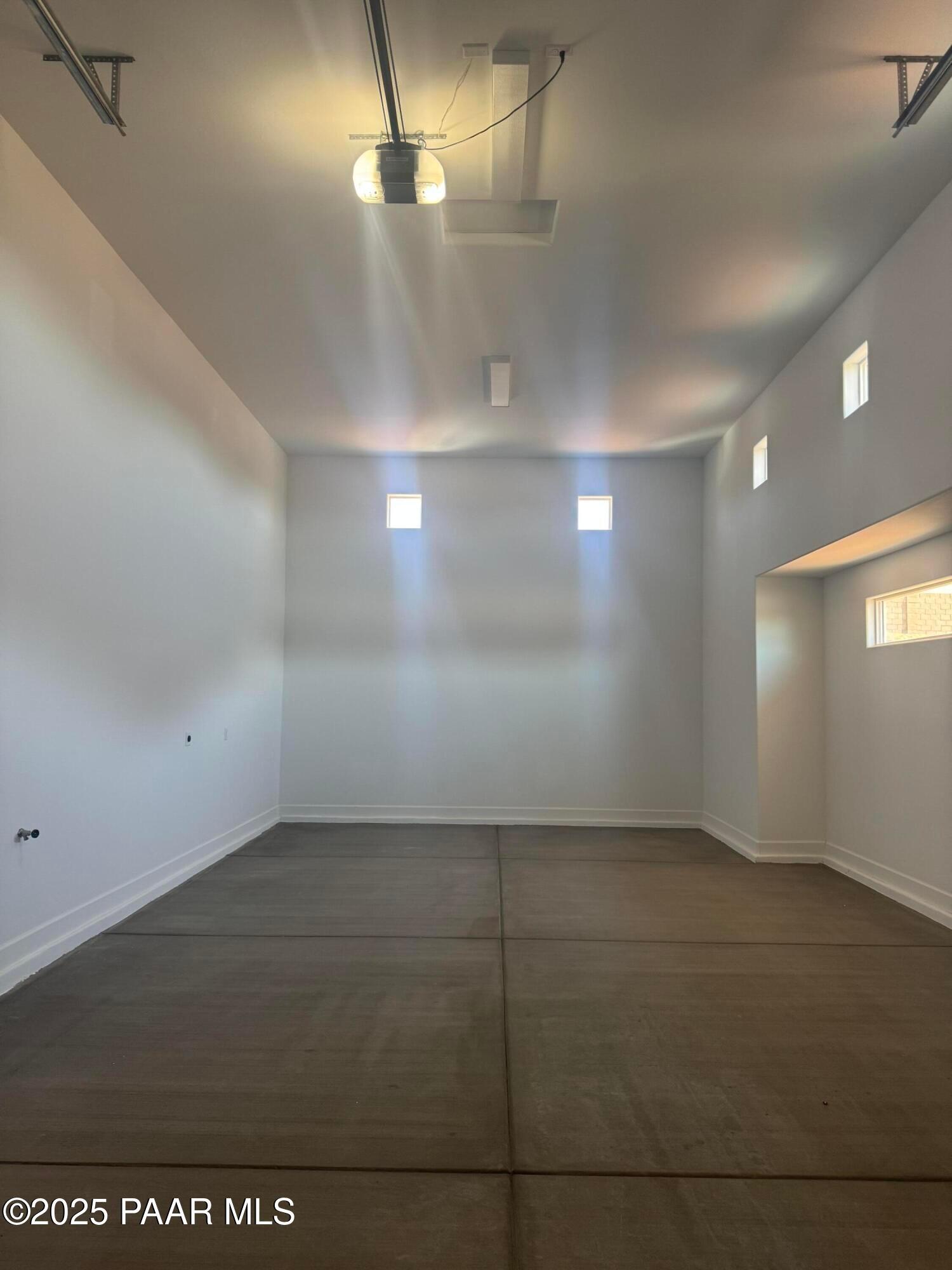 Spacious 2-car garage with polished concrete floor and clerestory windows in Evermore Homes The Summit B, Prescott Valley, Arizona