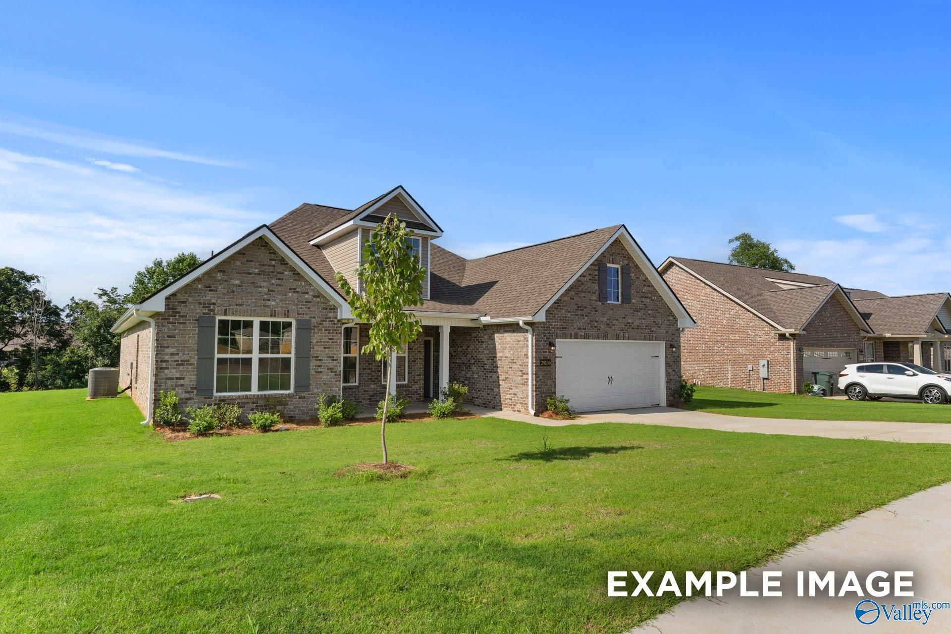 Beige brick 1.5-story Davidson Homes The Rockford with Bonus, 4-bedroom, 2-car garage facade in Barnett's Crossing, Madison, Alabama