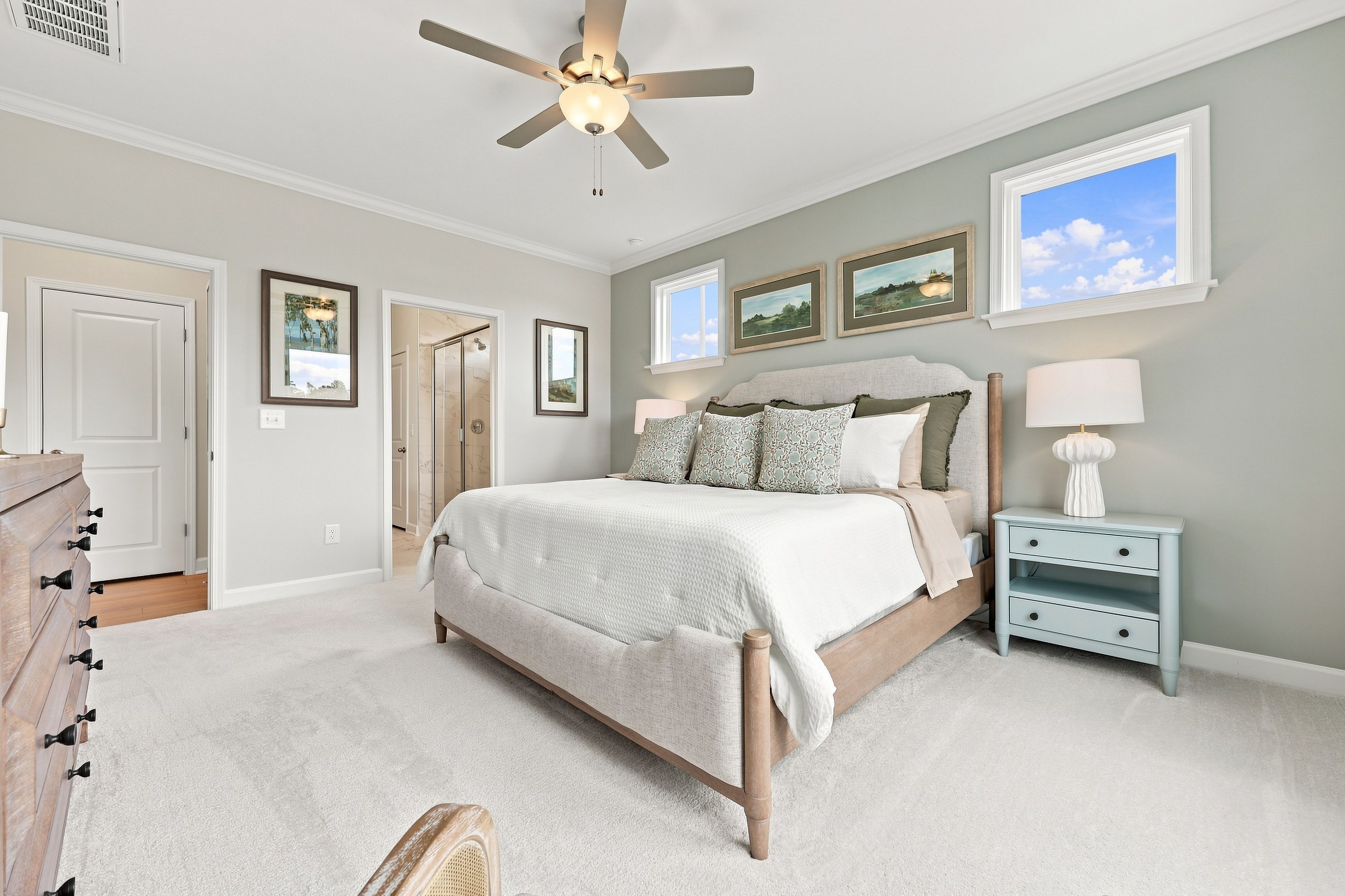 Spacious master suite in The Daphne home design featuring a king bed, neutral decor, and an en-suite bathroom.