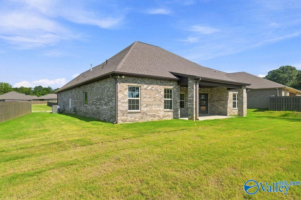 Brick exterior and covered back patio of The Rockford floor plan by Davidson Homes in Cain Park, Hartselle, Alabama.