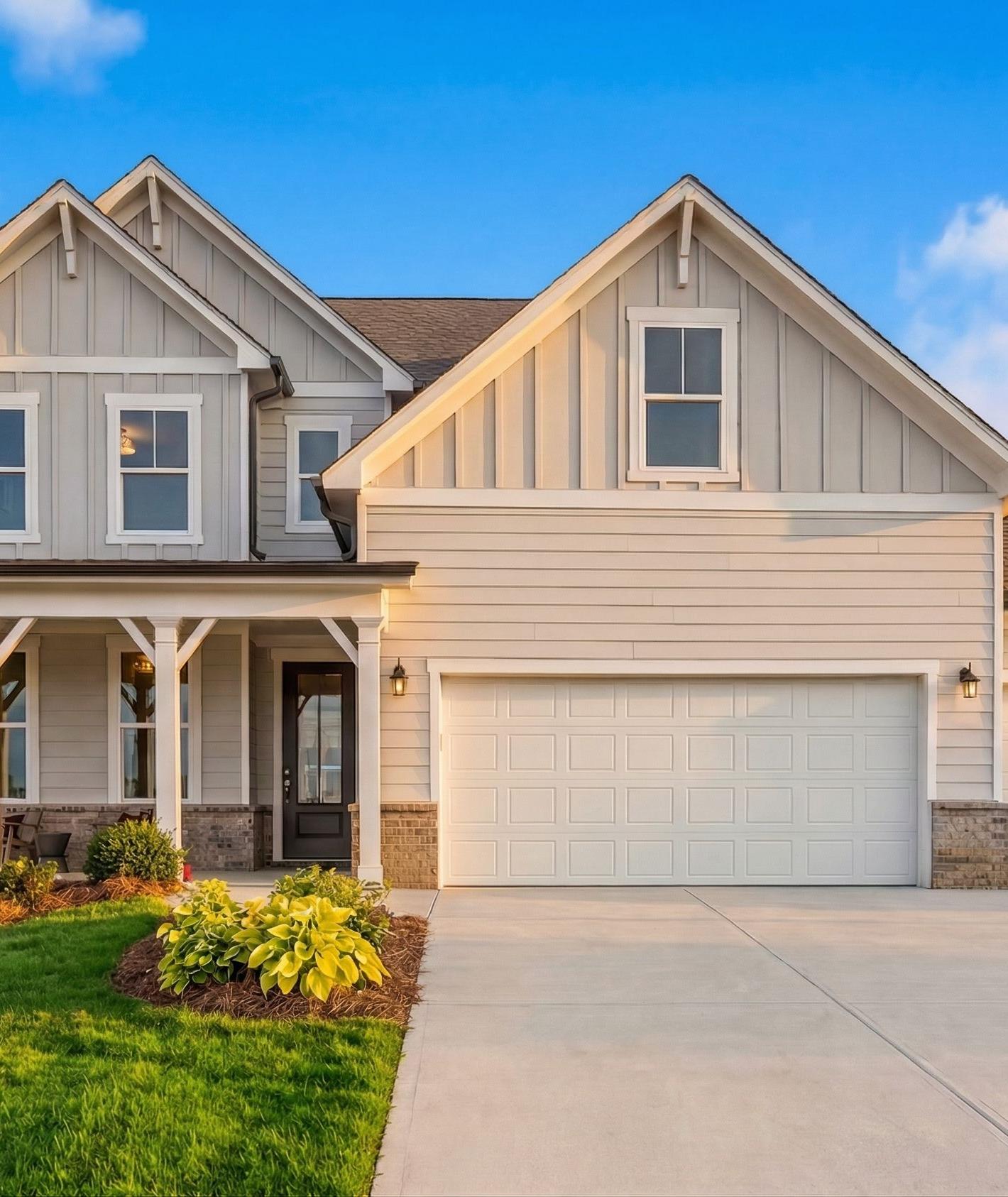 Modern farmhouse exterior by Davidson Homes at Wehunt Meadows in Hoschton, Georgia with a covered front porch and garage.