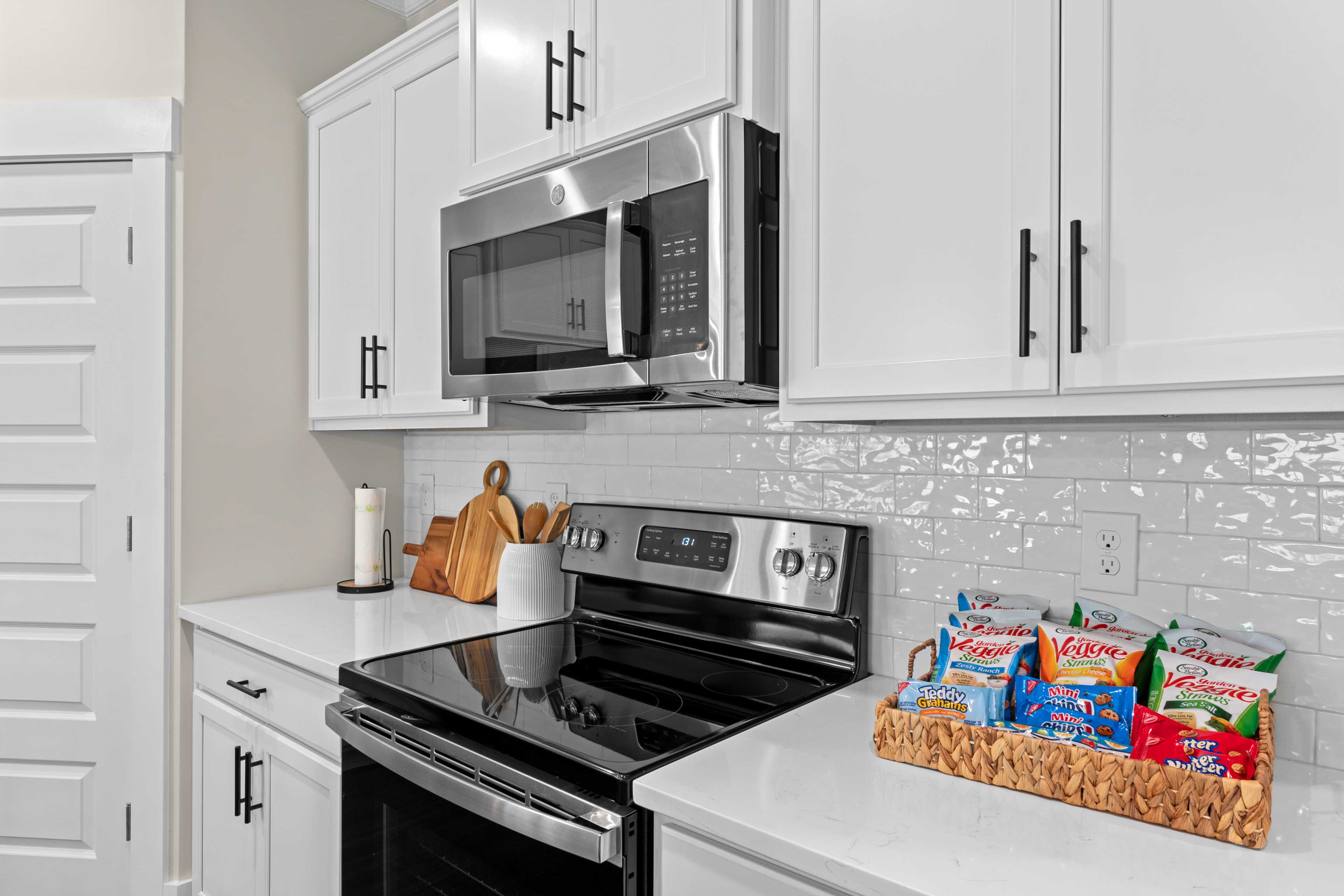 Spacious kitchen in Ivy Hills Toney Alabama with white shaker cabinets, stainless steel appliances, subway tile backsplash