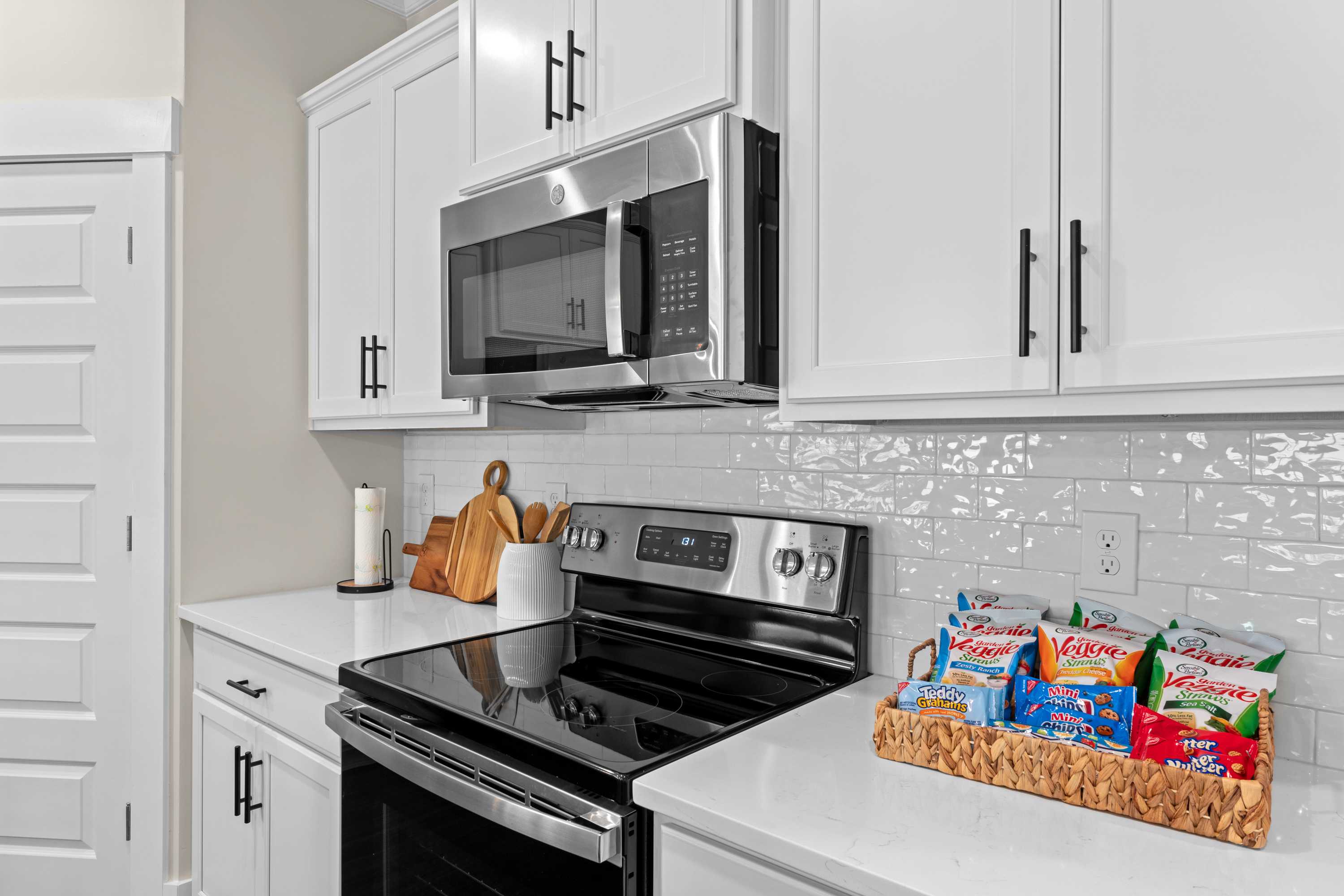 Spacious kitchen in Ivy Hills Toney Alabama with white shaker cabinets, stainless steel appliances, subway tile backsplash