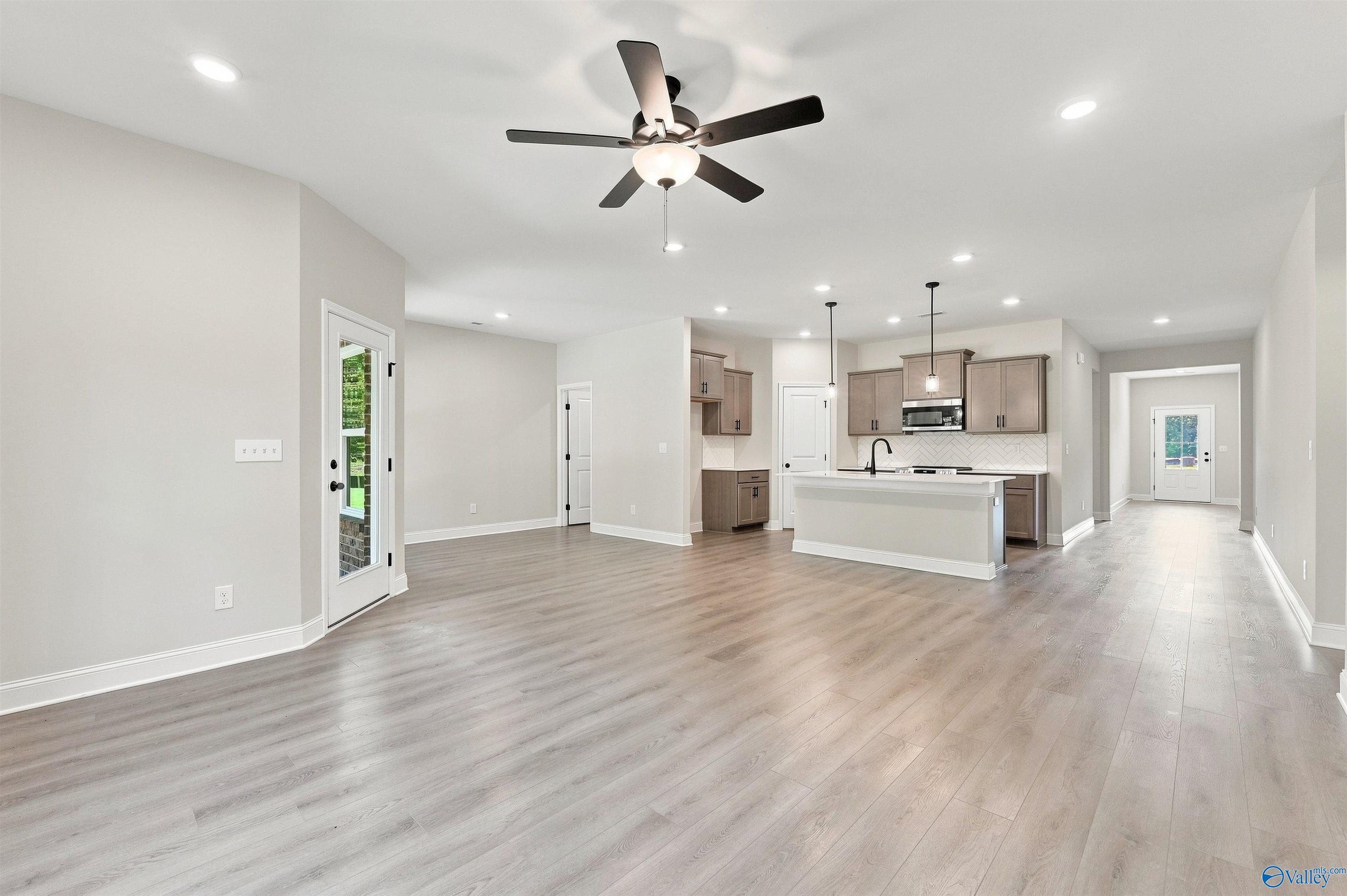 Open-concept living room and kitchen in The Daphne floor plan by Davidson Homes in Spragins Cove, Huntsville, Alabama.