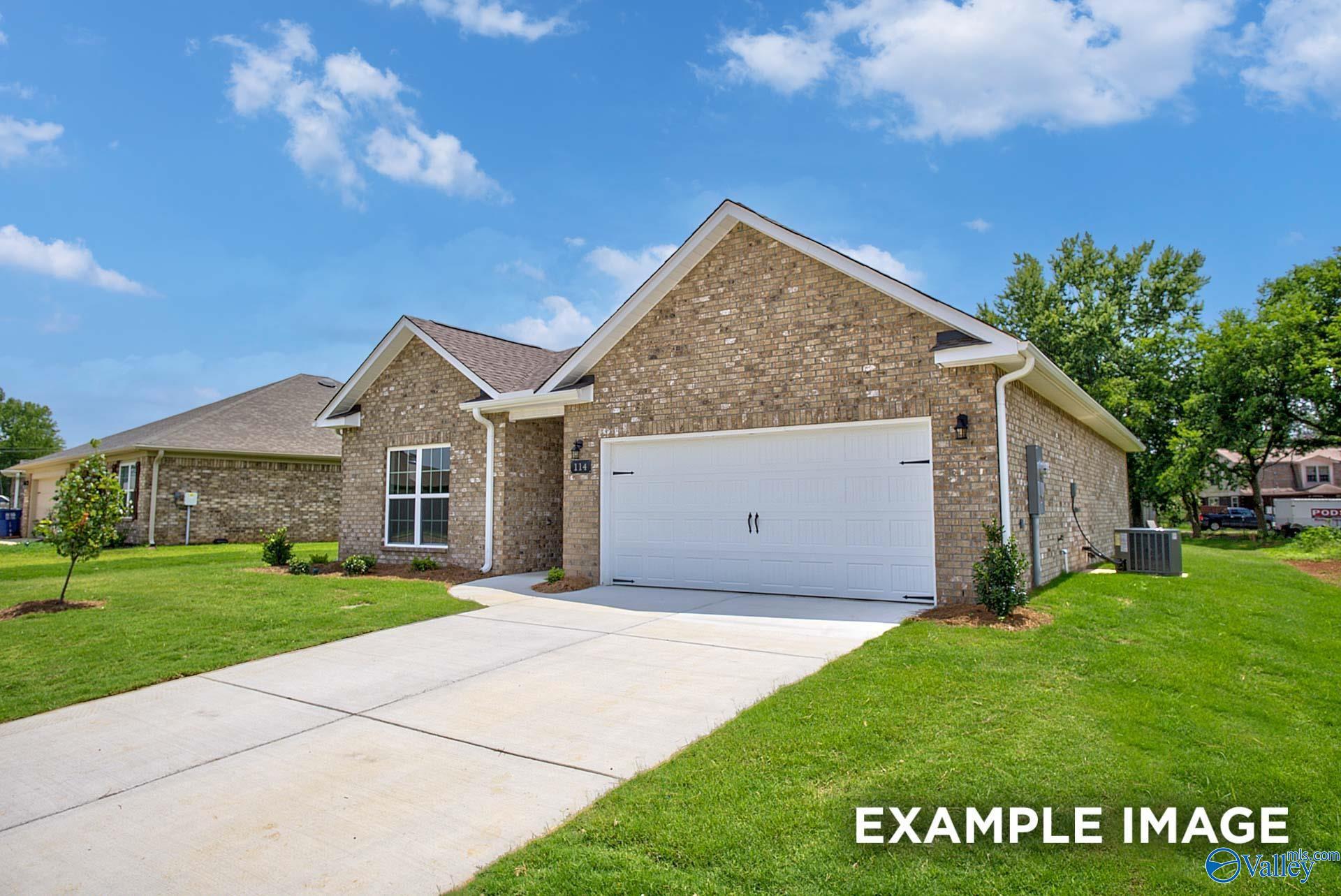 Brick single-story home with 2-car garage, driveway, and lush green lawn in Lynn Meadows, Meridianville, Alabama - Davidson Homes The Asheville C