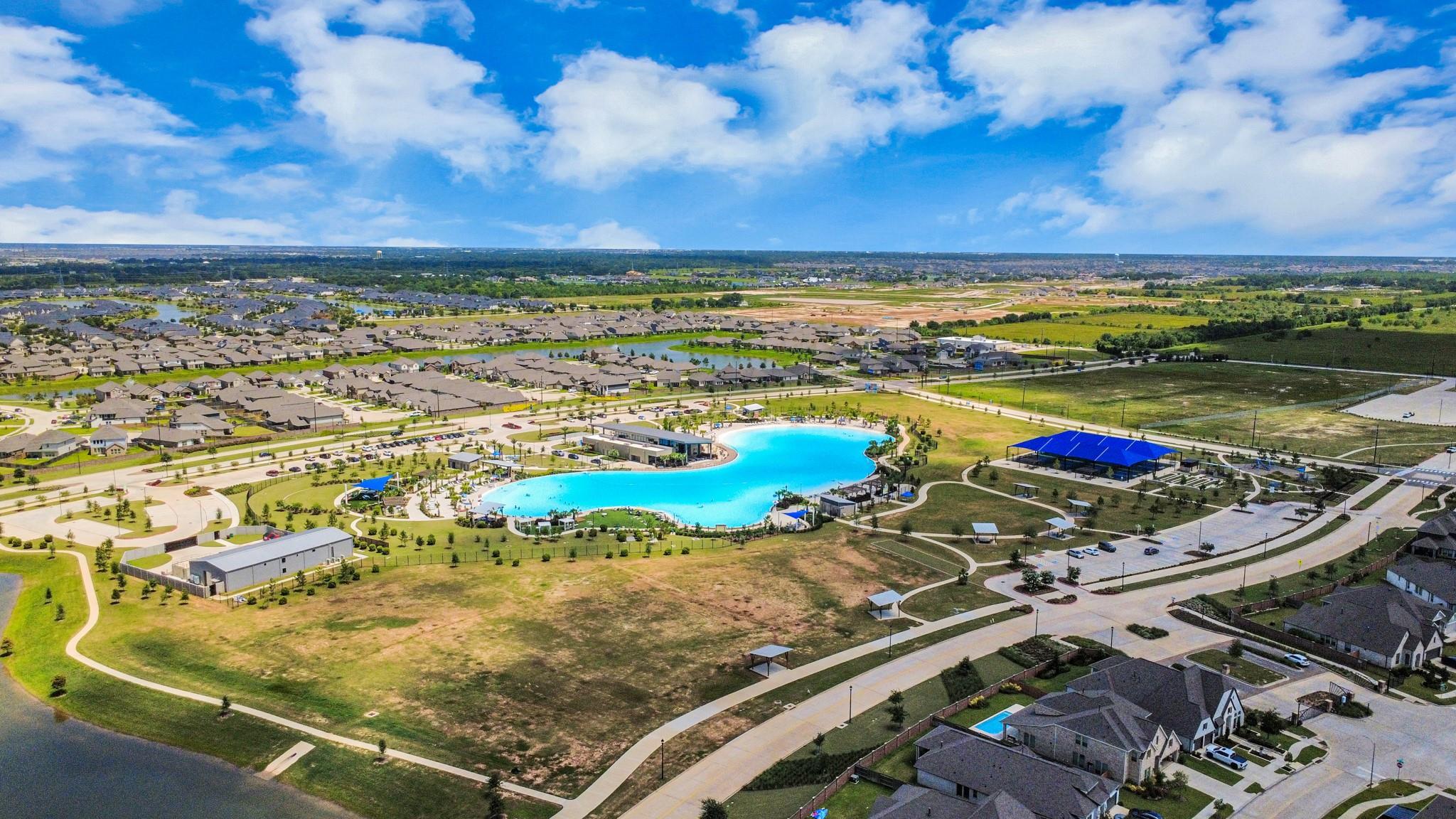 Aerial view of the crystal lagoon and community amenities in Sunterra, Katy, Texas near Davidson Homes.