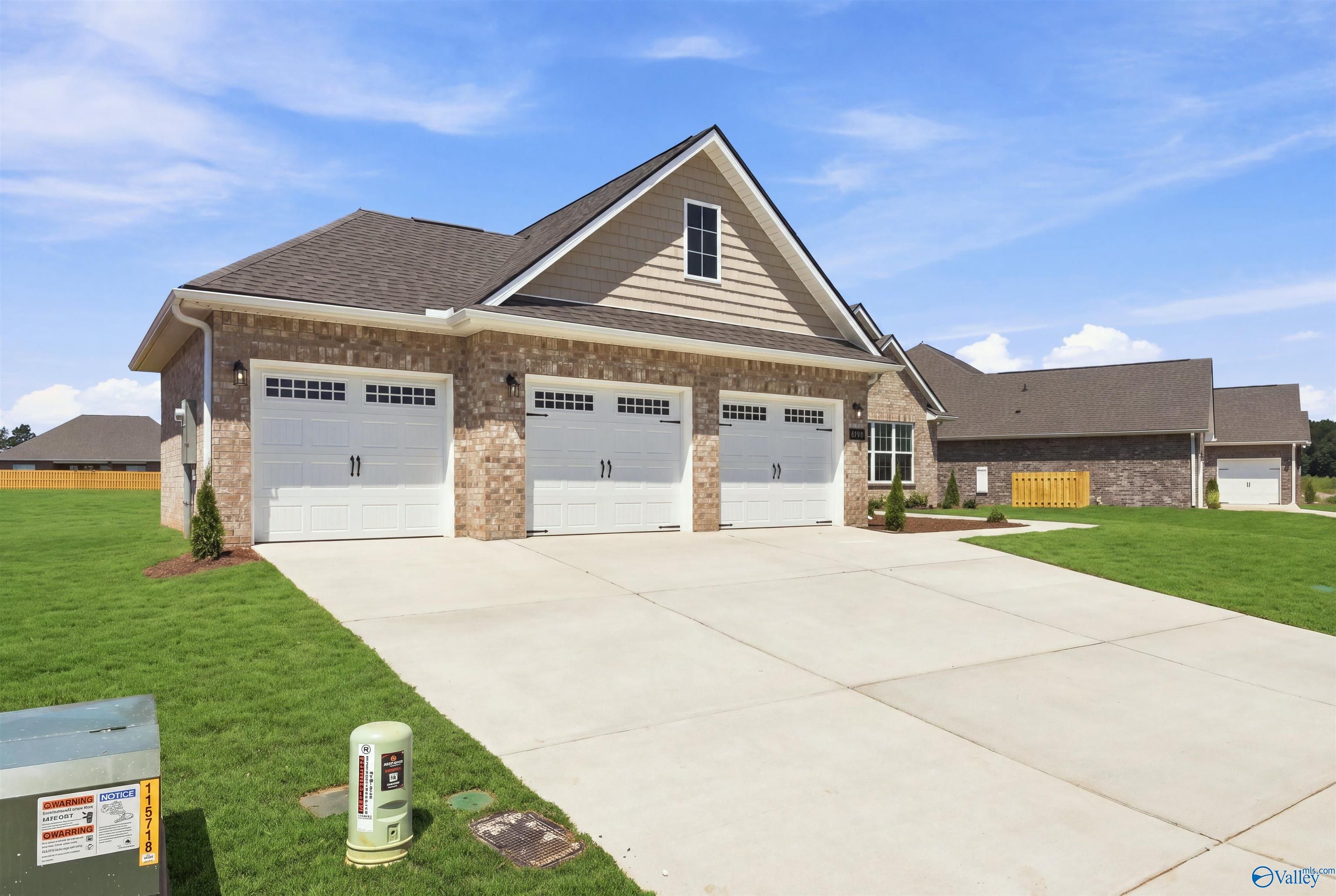 Exterior of The Oxford floor plan by Davidson Homes featuring a 3-car garage in Kendall Farms, Toney, Alabama.