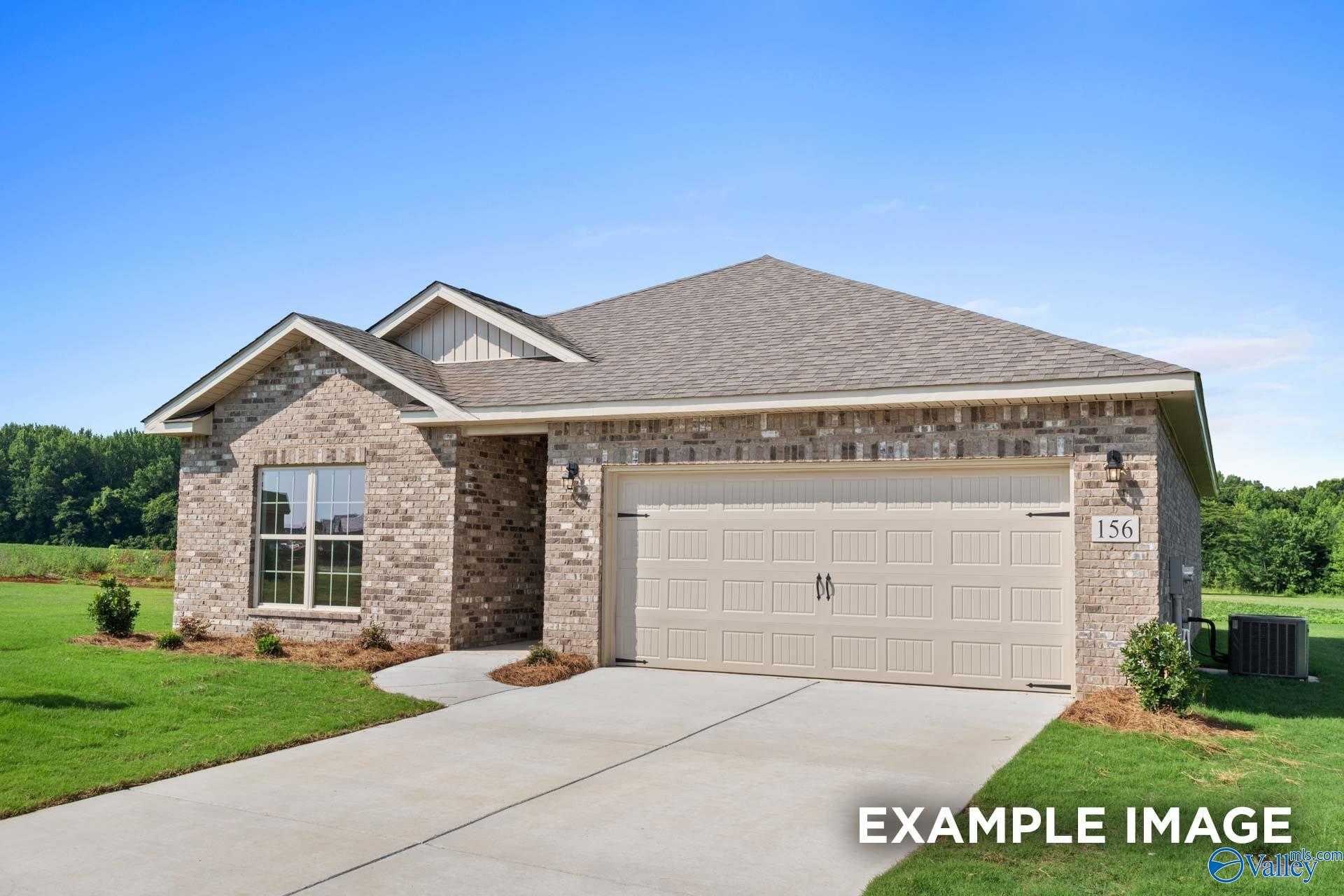 Modern brick single-story home with 2-car garage, driveway, and lush landscaping in The Highlands, Arab, Alabama - Davidson Homes The Asheville
