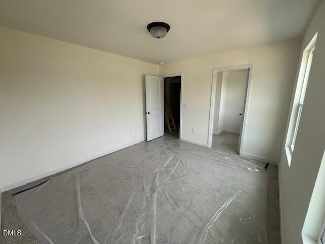 Unfinished bedroom with carpet protection in The Hickory II B floor plan at Retreat at North Main, Lillington, NC.