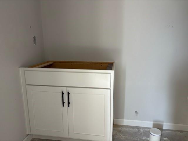 White shaker bathroom vanity with black handles in unfinished suite, The Hickory B by Davidson Homes, Winder, GA