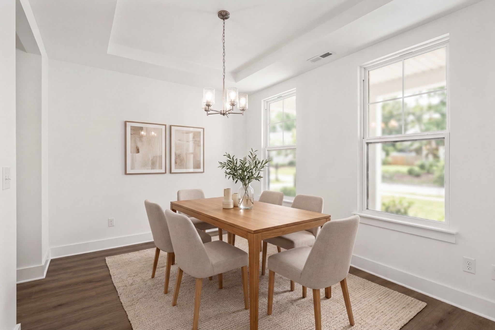 Bright dining room with wood table and upholstered chairs in The Willow D floor plan at Benders Cove, Mt. Juliet, Tennessee.