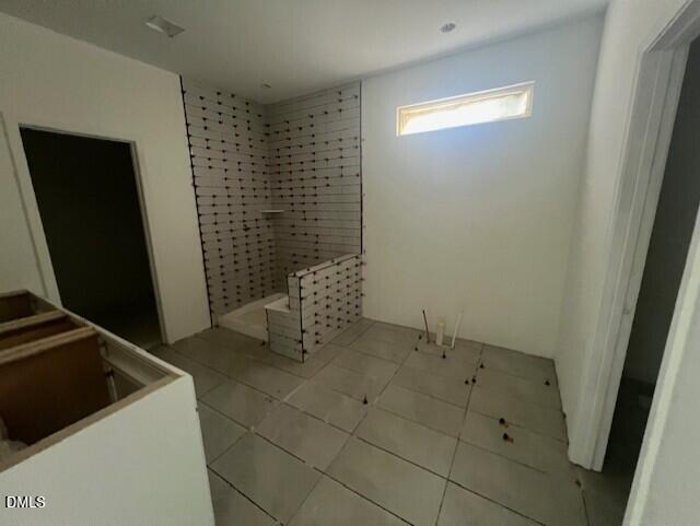 Bathroom under construction with tiled walk-in shower and floor in Davidson Homes Magnolia II B plan, Lillington, NC