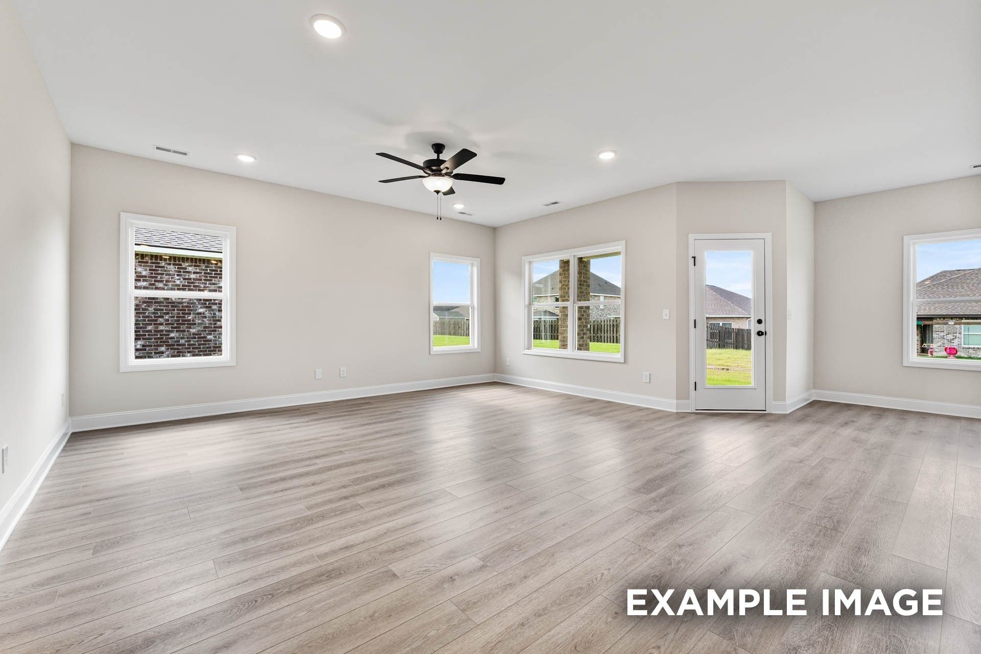 Spacious living room with wood-look flooring and ceiling fan in The Franklin E floor plan at Bailey Park, Fayetteville, TN.