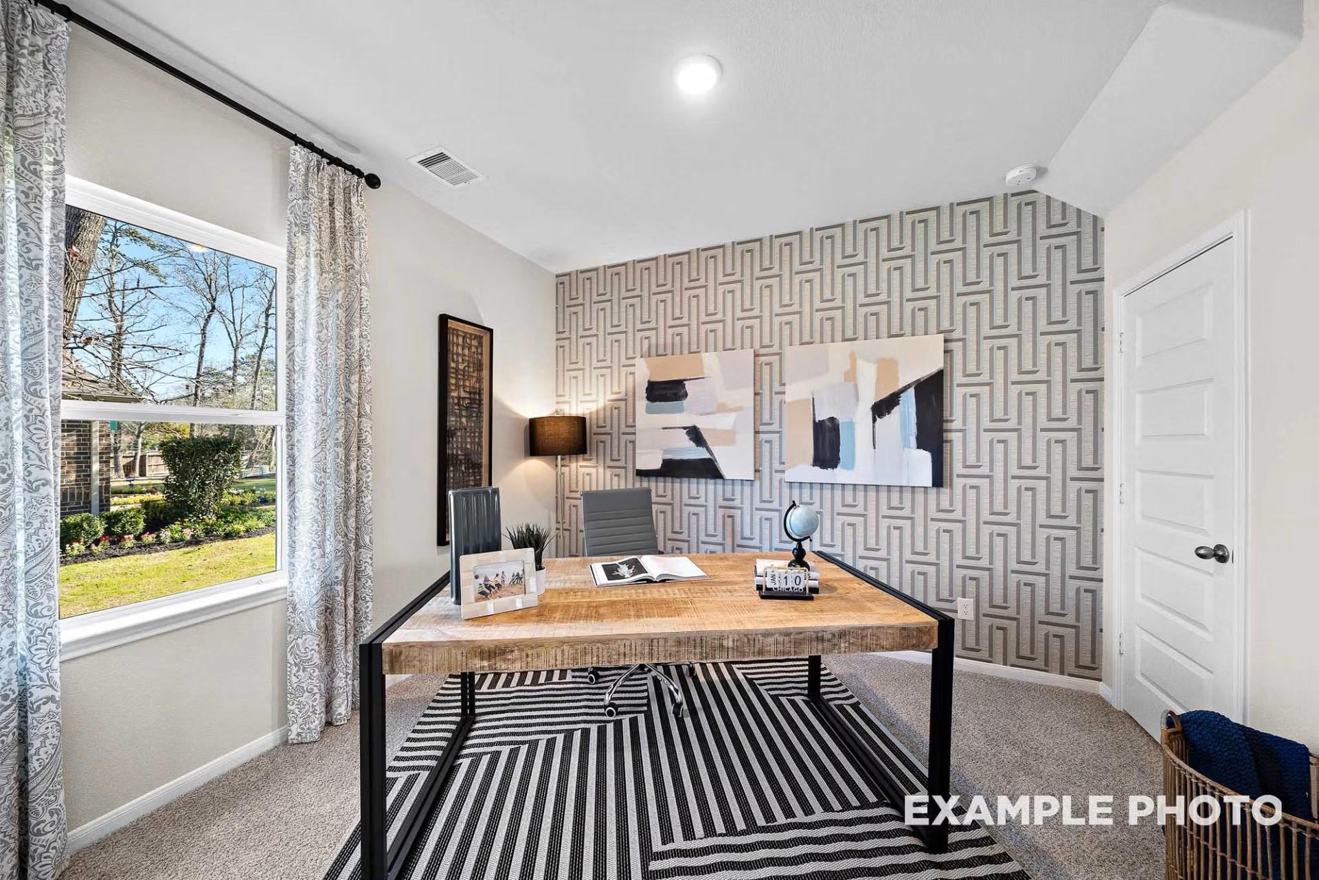 Modern home office with geometric wallpaper and rustic wooden desk in The San Marcos E floor plan by Davidson Homes.