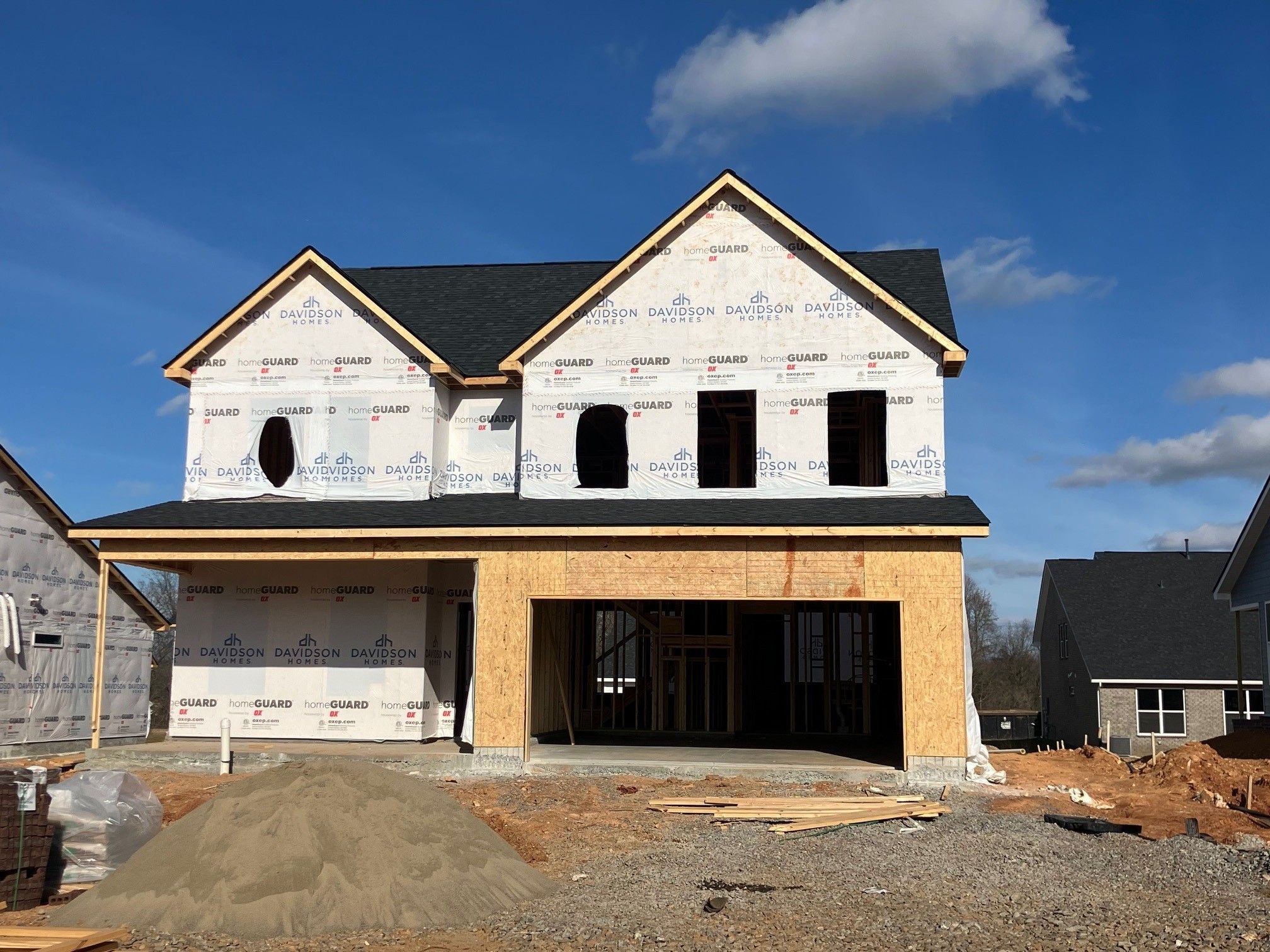 Davidson Homes Willow B 2-story 3-bedroom under construction with sheathed exterior, shingled roof, and 2-car garage in Calista Farms, White House, TN
