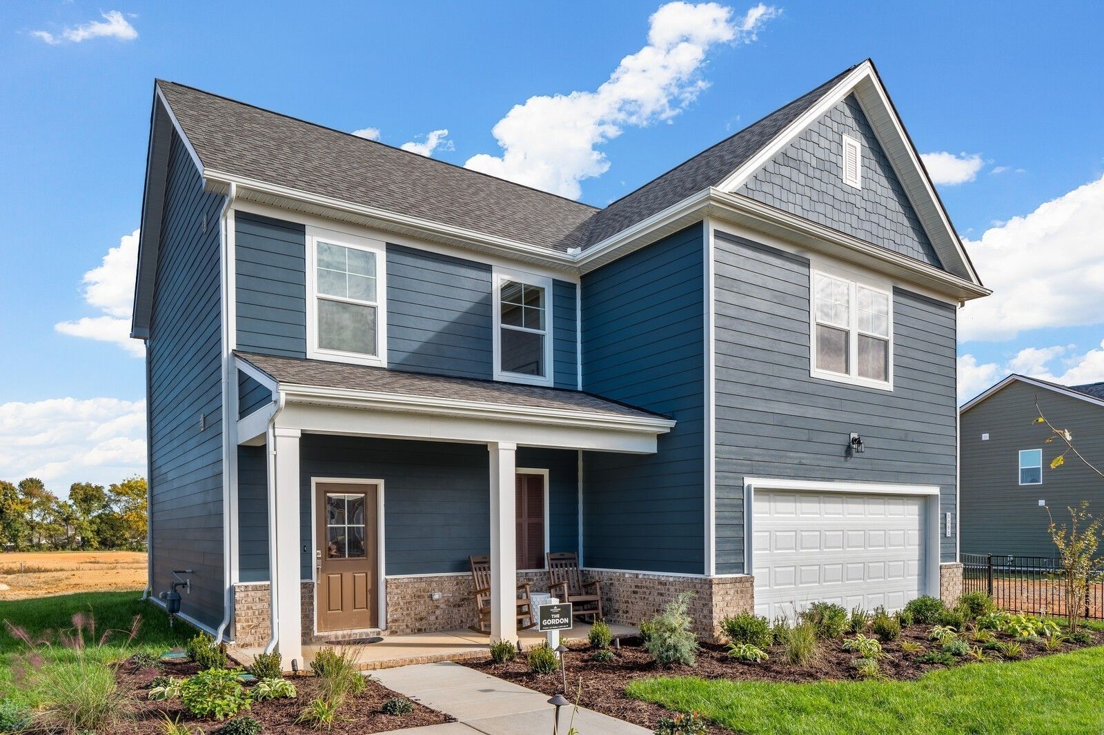 Blue two-story exterior of The Gordon C floor plan by Davidson Homes in Sage Farms, White House, Tennessee.
