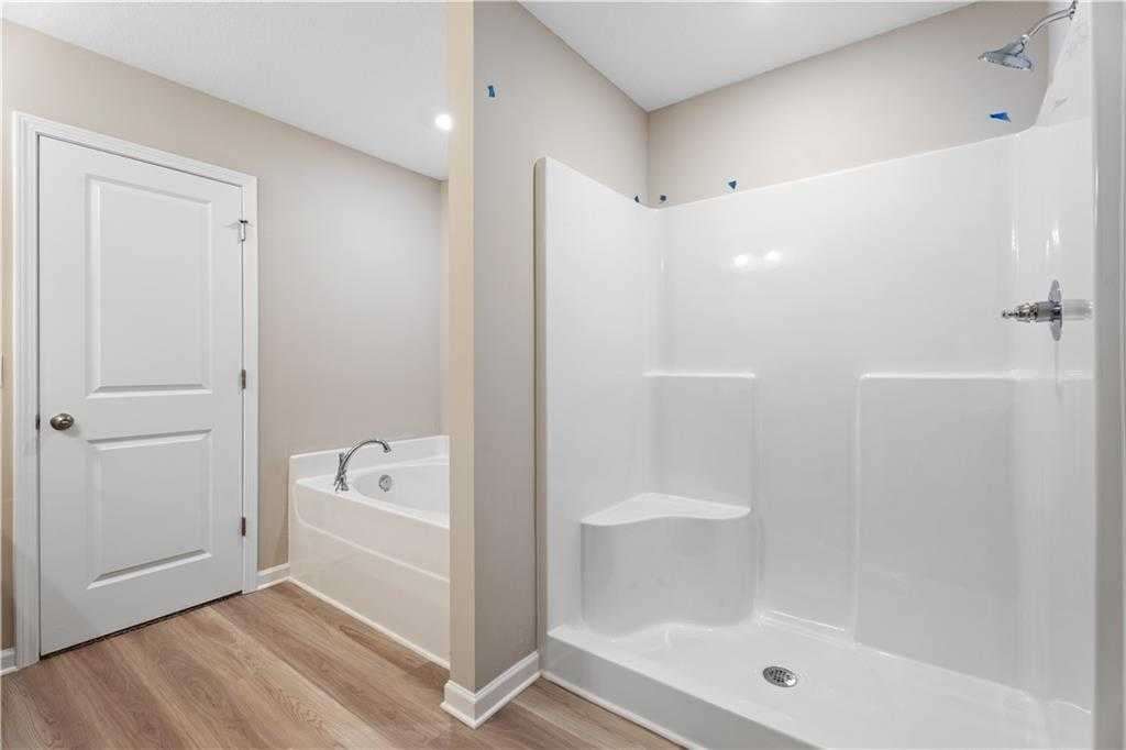 Modern master bathroom with soaking tub and glass walk-in shower in Davidson Homes The Bartlett, Phenix City, Alabama