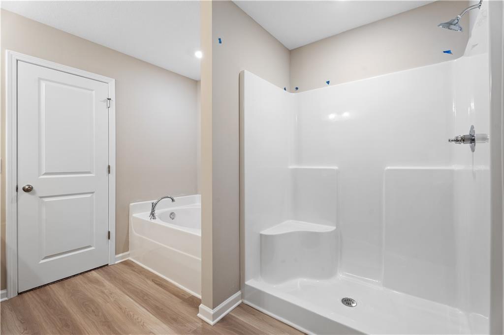 Modern master bathroom with soaking tub and glass walk-in shower in Davidson Homes The Bartlett, Phenix City, Alabama