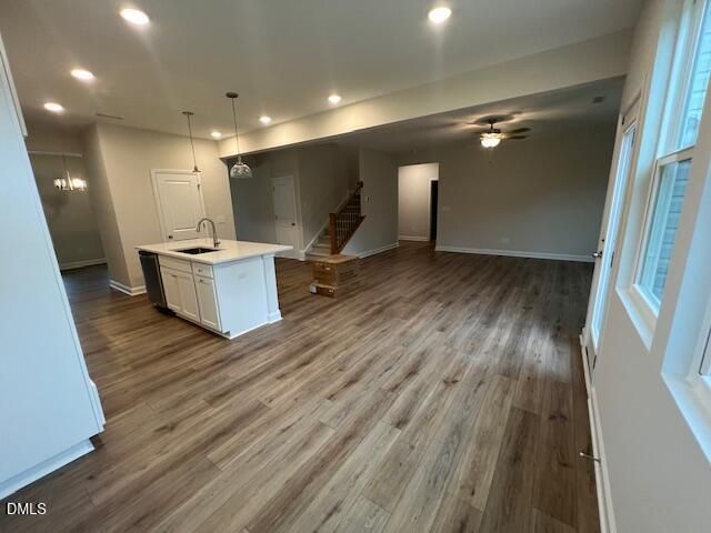 Open-concept kitchen island with white cabinetry and hardwood-style flooring in Davidson Homes' The Willow D, Wellers Knoll, Lillington NC