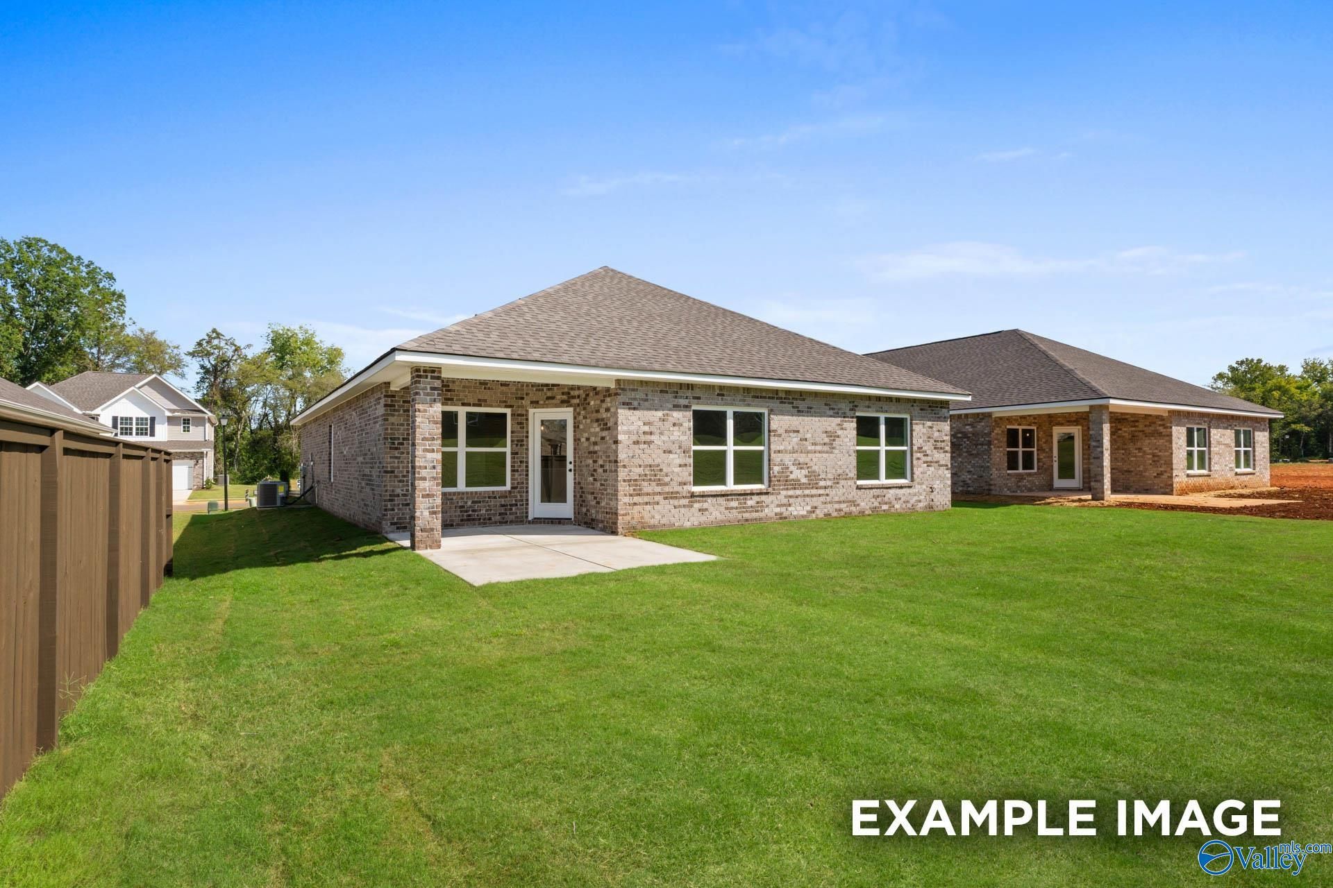 Brick single-story home with gabled roof, covered porch, and lush green yard in Walker's Hill, Meridianville, Alabama