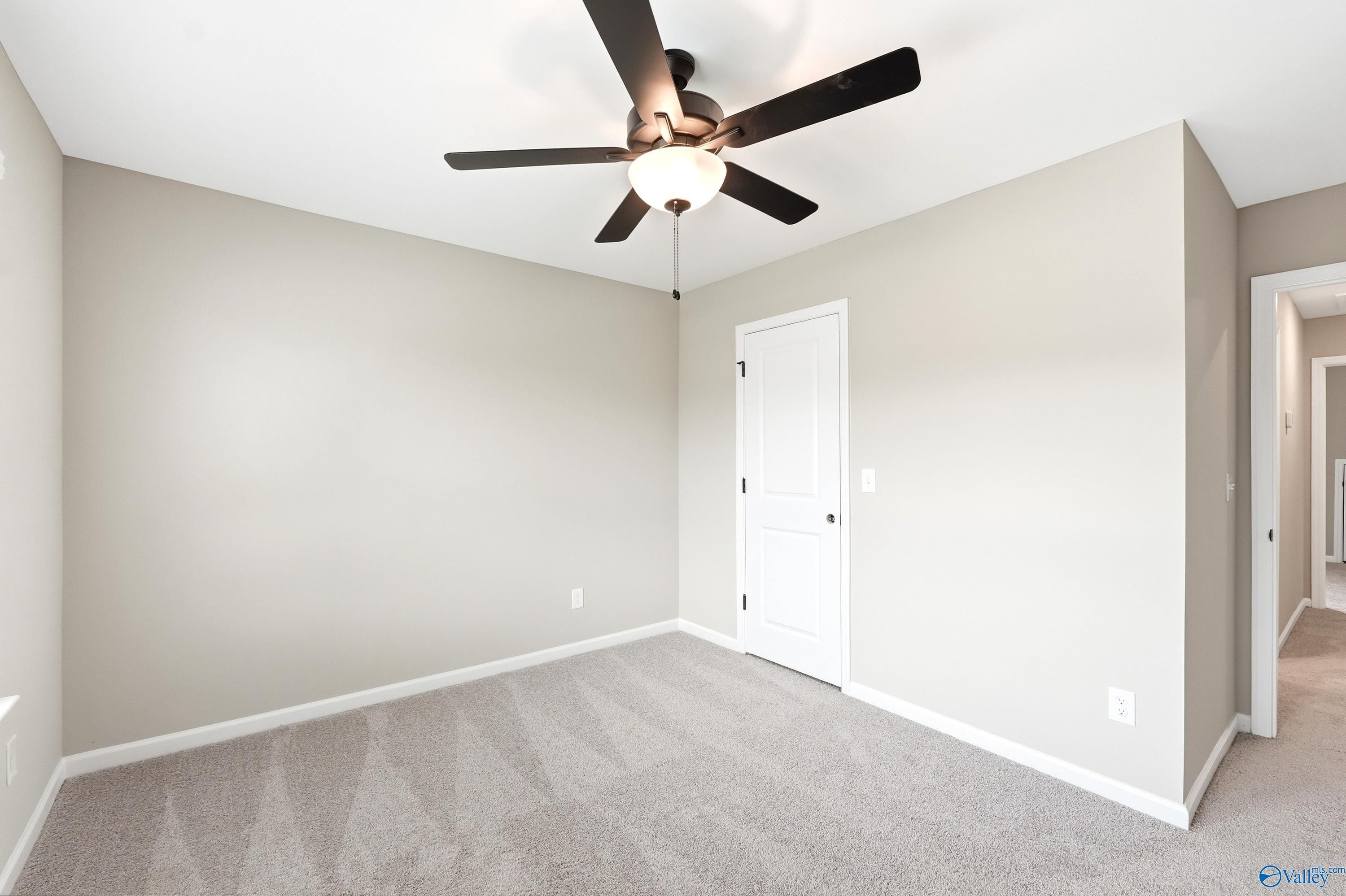 Spacious carpeted bedroom with ceiling fan in The Dorado floor plan by Davidson Homes at Riverton Preserve, Huntsville, AL.