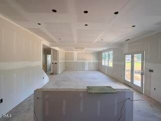 Spacious open-concept living area under construction in The Hickory II B floor plan at Woodland Crossing, Zebulon, NC.