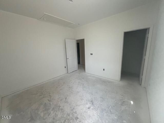 Empty bedroom with fresh white walls and concrete flooring in Davidson Homes Magnolia II B new construction home, Lillington NC