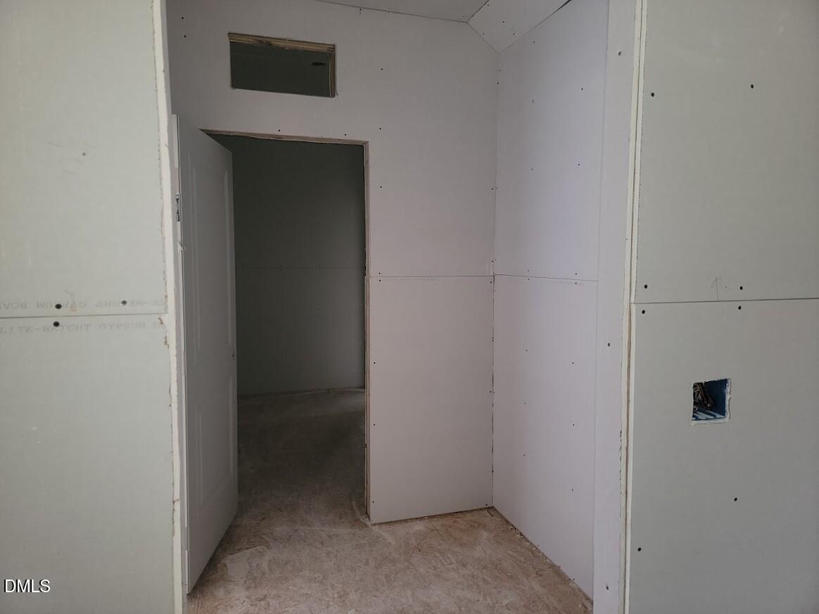 Unfinished bedroom interior with drywall walls, open doorway, and rough openings in The Ashport G 5-bedroom home, Angier NC