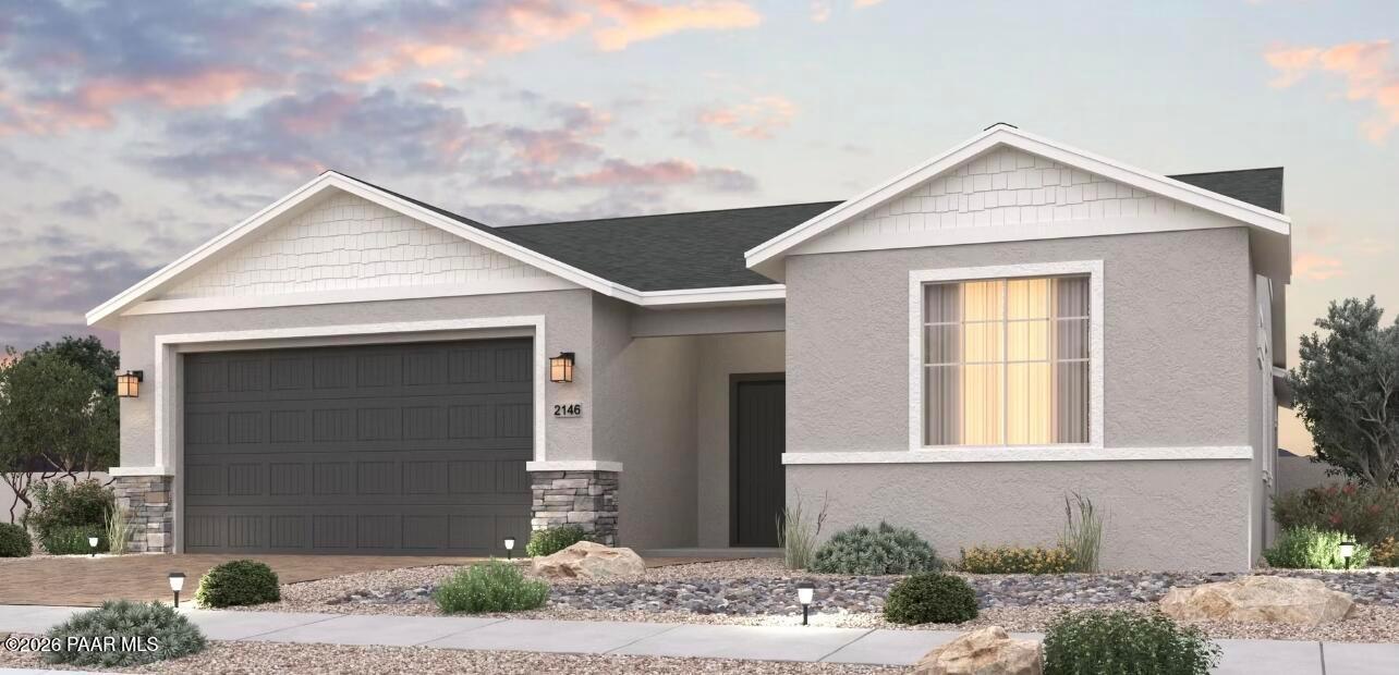 Modern single-story 3-bedroom home with 3-car garage, stone accents, and desert landscaping in North Ridge at Pronghorn Ranch, Prescott Valley, Arizona