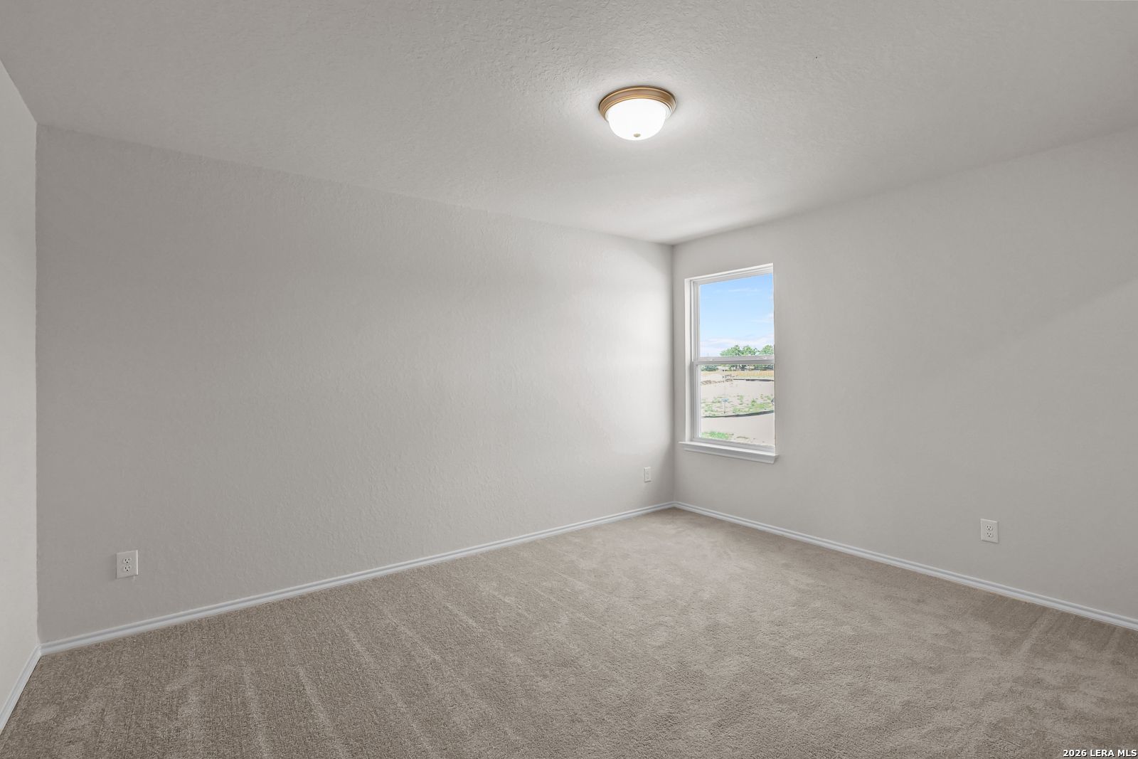 Spacious bedroom with neutral carpet and natural light in The San Marcos F floor plan by Davidson Homes, San Antonio, TX.