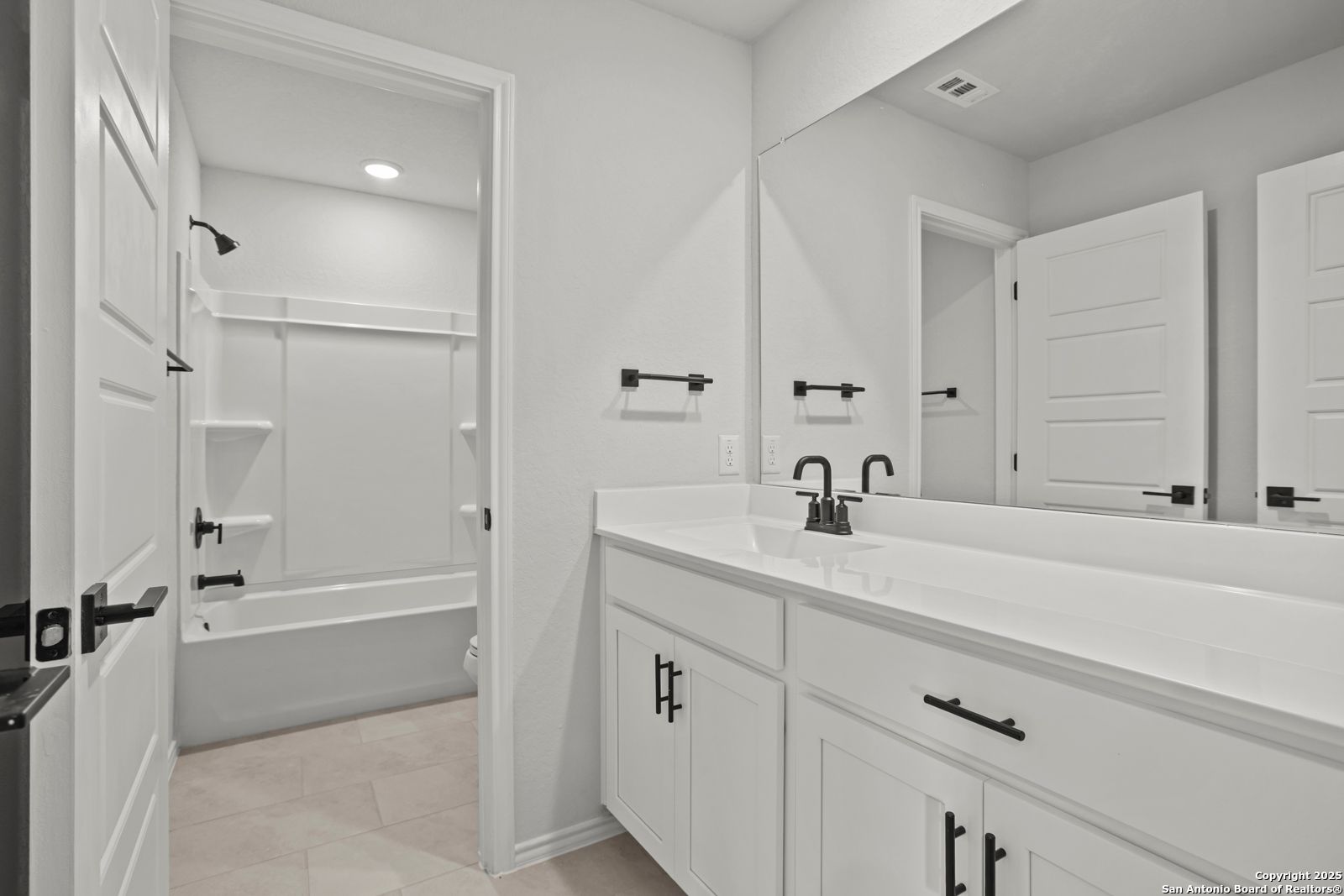 Modern bathroom with double sink vanity, soaking tub, and walk-in shower in Davidson Homes The Douglas C, Seguin, TX