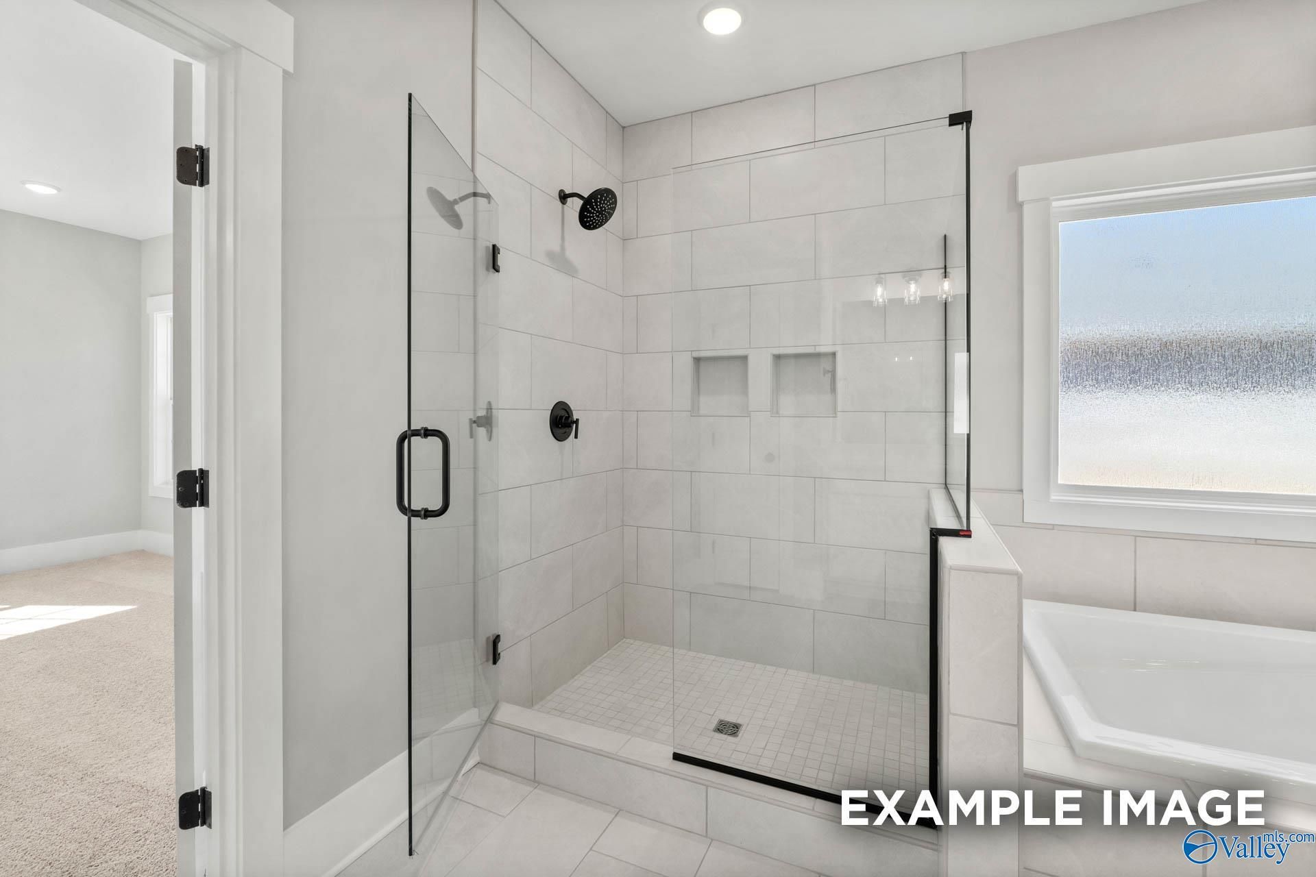 Modern walk-in tile shower with glass enclosure in The Finleigh floor plan home at Briercreek in Meridianville, Alabama.