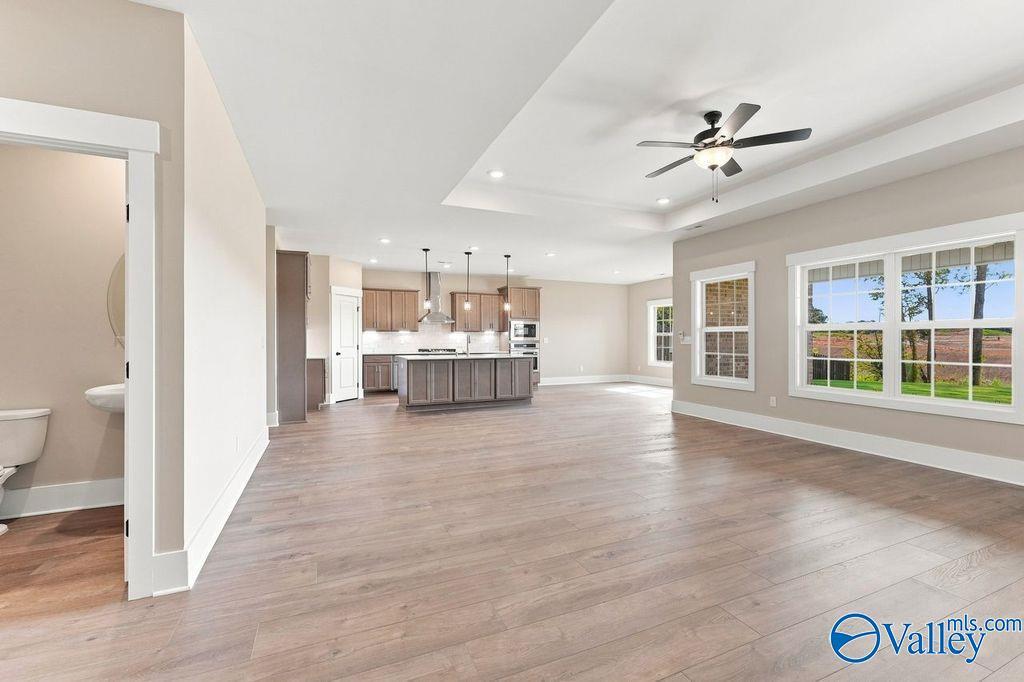 Open-concept living room and kitchen in The Rockford floor plan by Davidson Homes in Cain Park, Hartselle, Alabama.