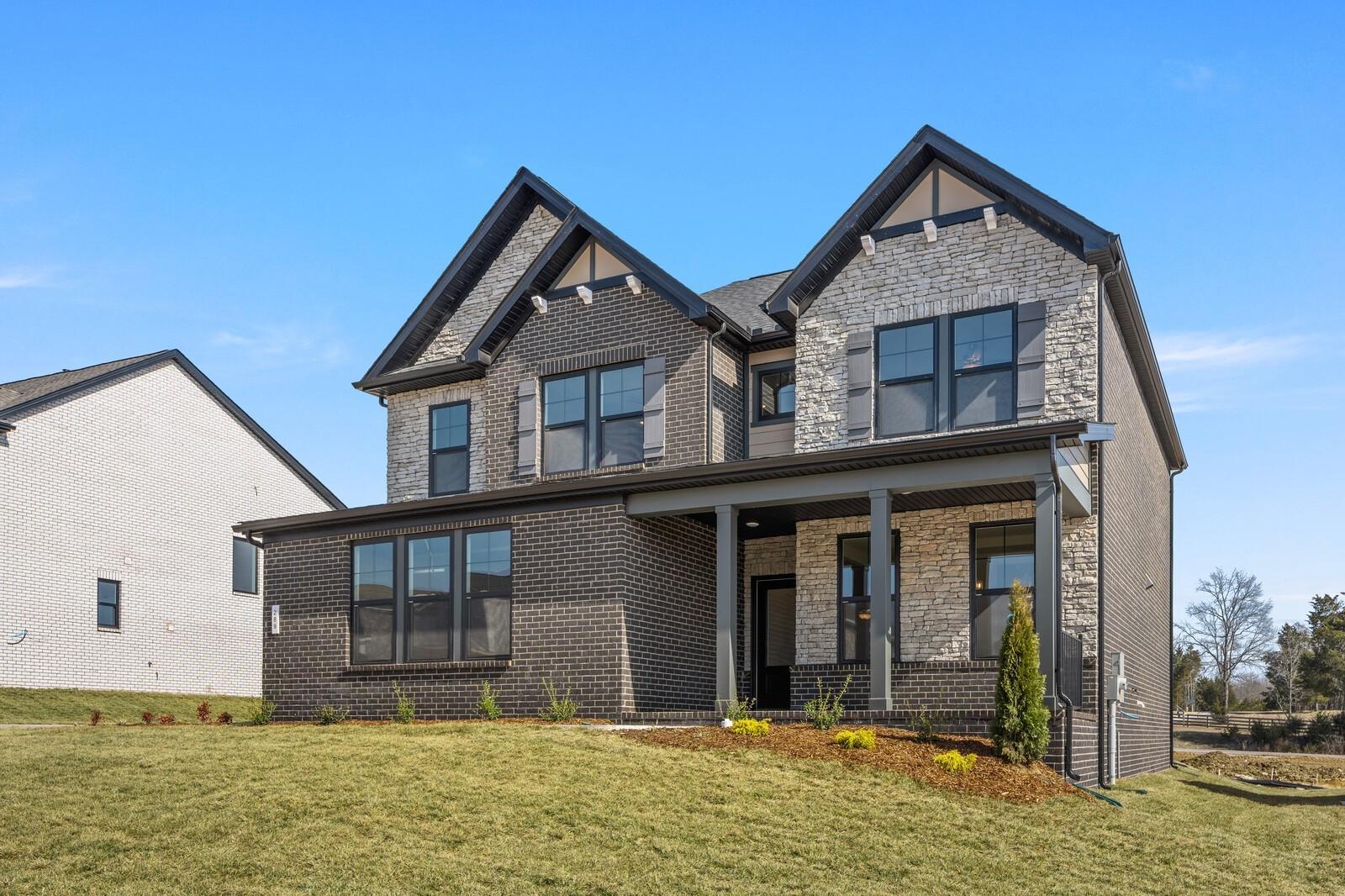Modern 2-story brick home with covered front porch, stone accents, and 2-car garage in Benders Cove, Mt. Juliet, TN - Davidson Homes Willow D
