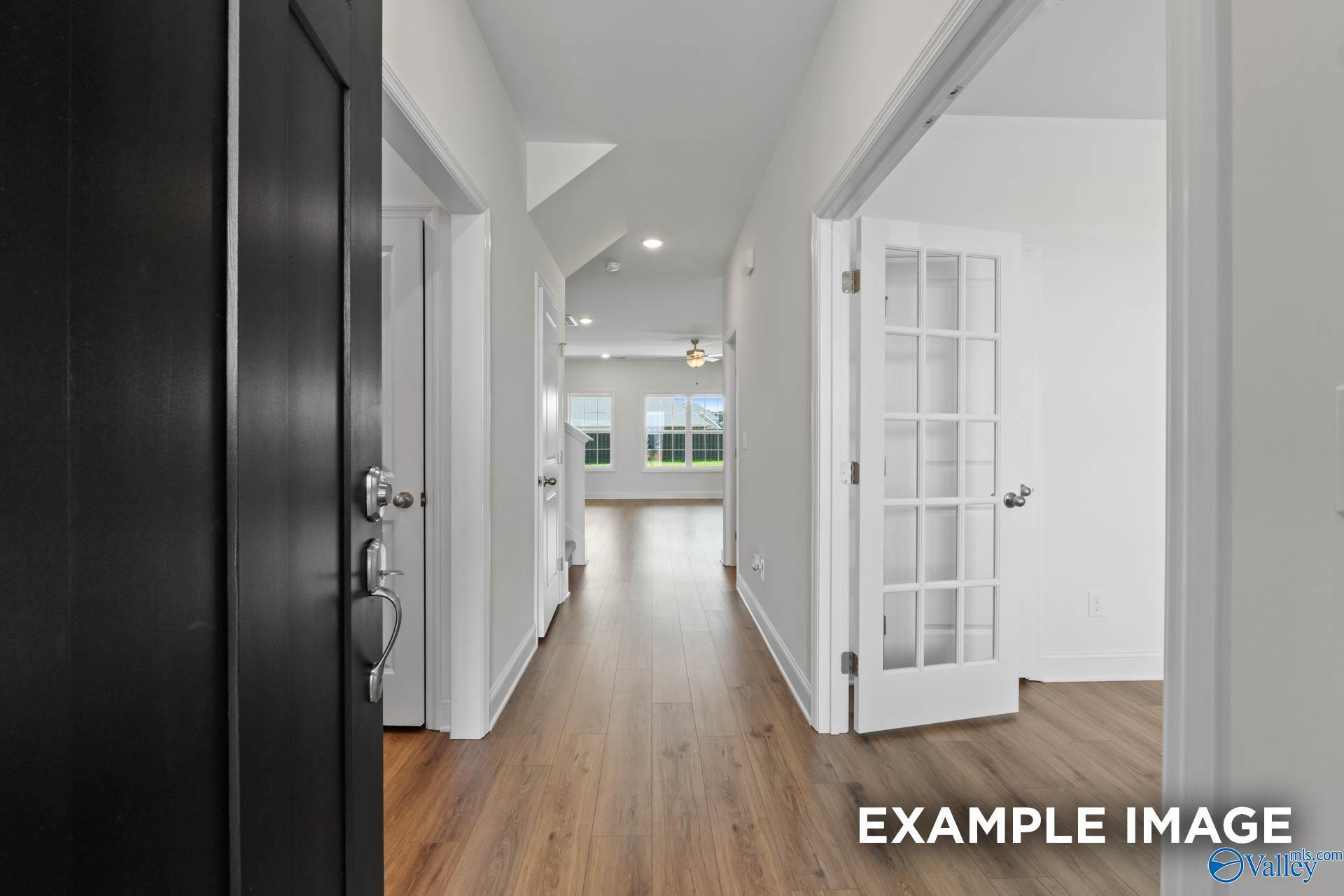 Welcoming entry hallway with hardwood floors, French doors, and natural light in Davidson Homes The Rockford B, Athens AL