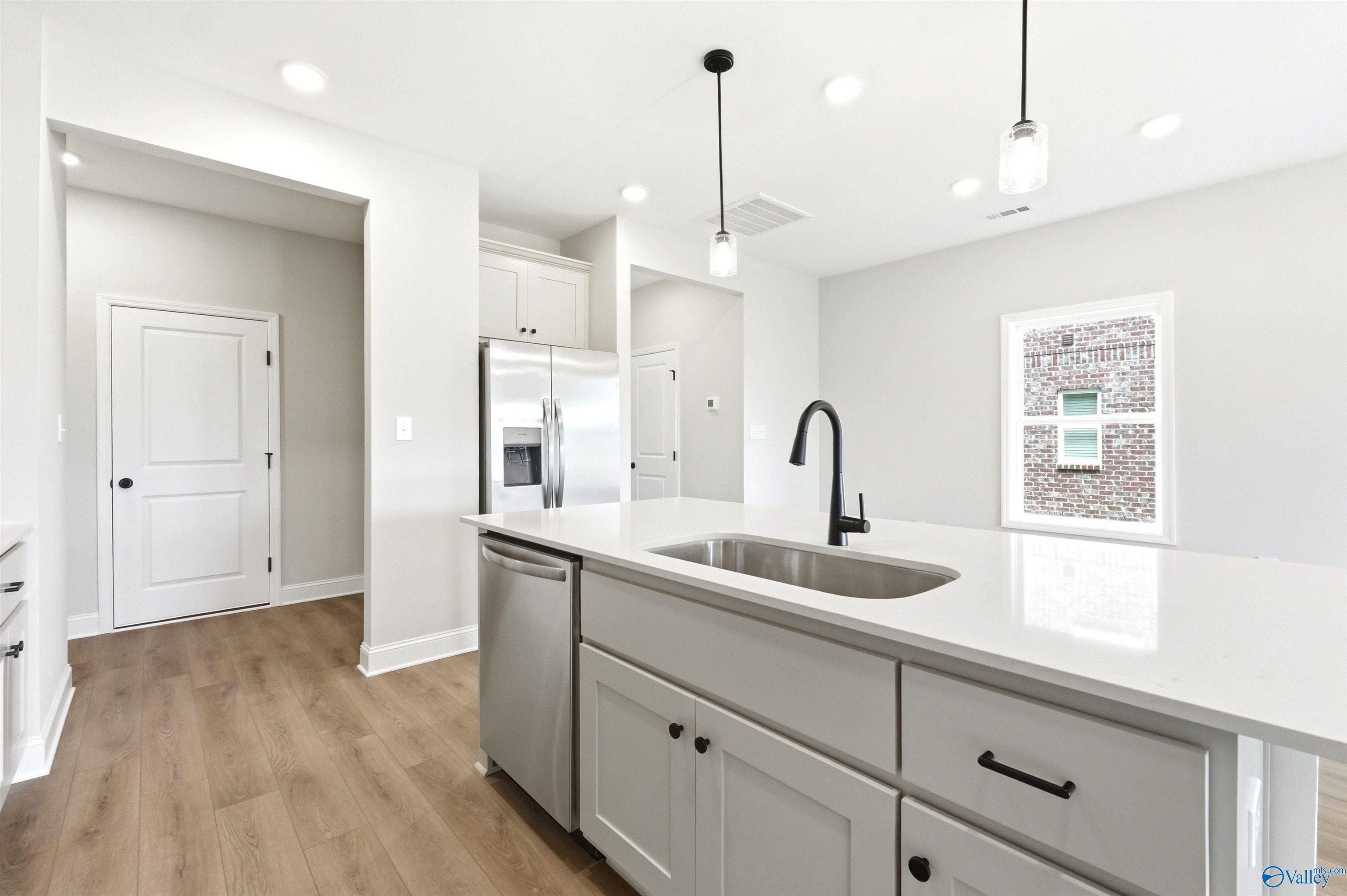Modern kitchen island with quartz countertops in The Meadowbrook A floor plan at Bailey Park in Fayetteville, Tennessee.
