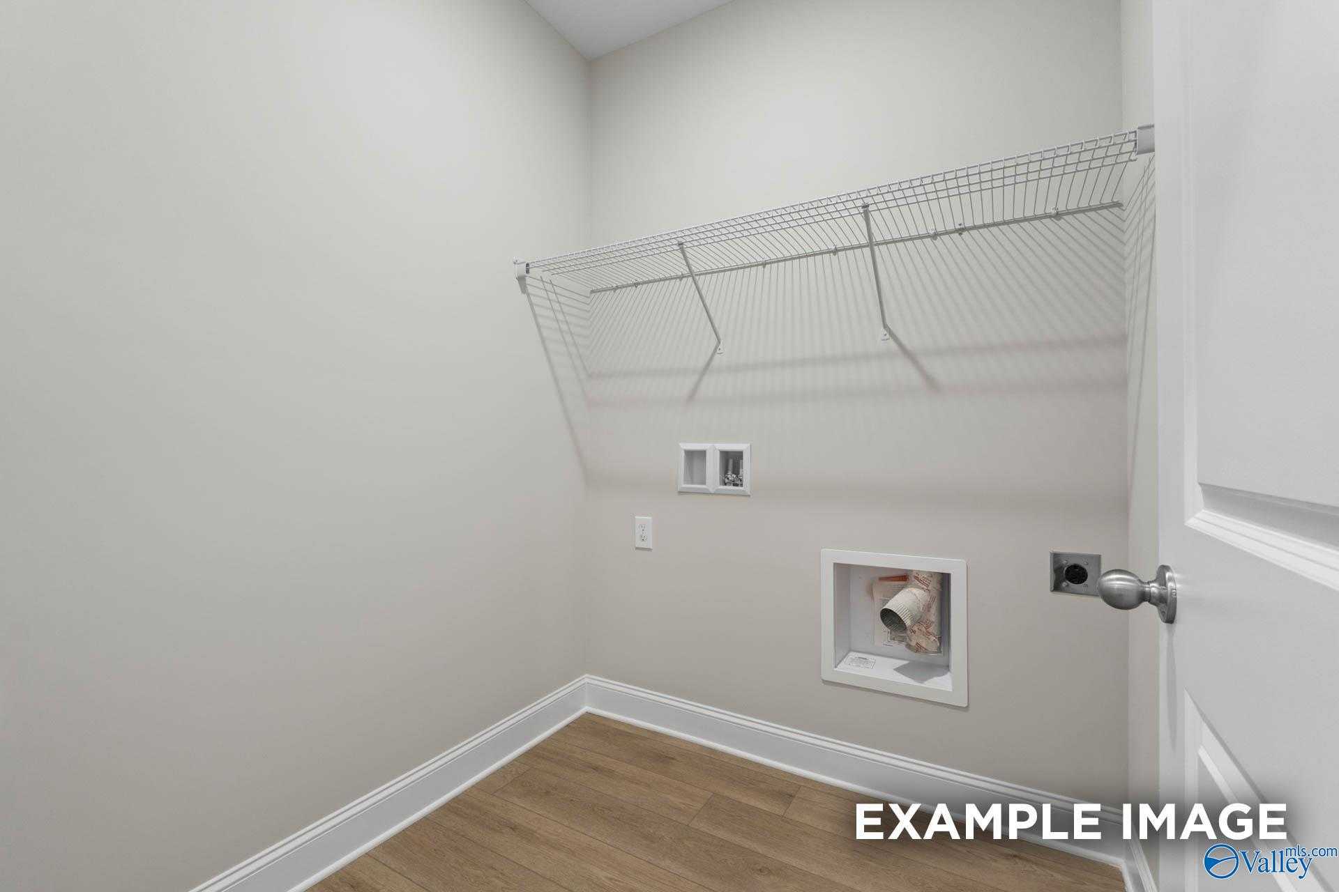 Functional laundry room with wire shelving, washer/dryer hookups in Davidson Homes The Franklin V, Athens, Alabama