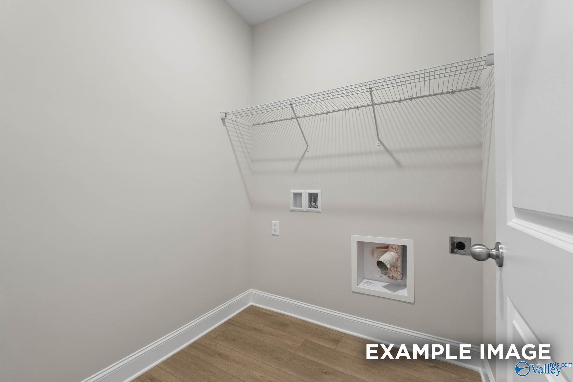 Functional laundry room with wire shelving, washer/dryer hookups in Davidson Homes The Franklin V, Athens, Alabama