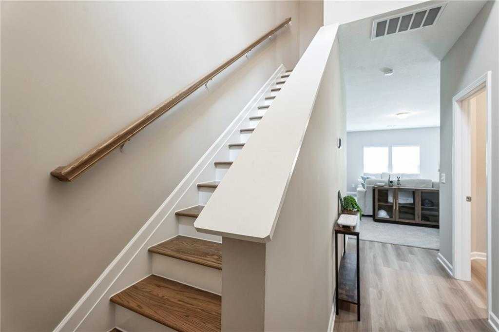 Elegant oak staircase with white risers and wooden railings in 2-story The Bartlett home, Phenix City, Alabama